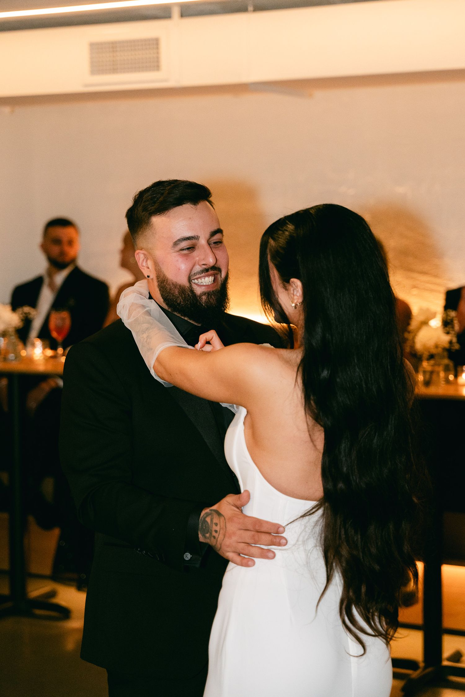A joyful dancing moment between newlyweds at their reception celebration.