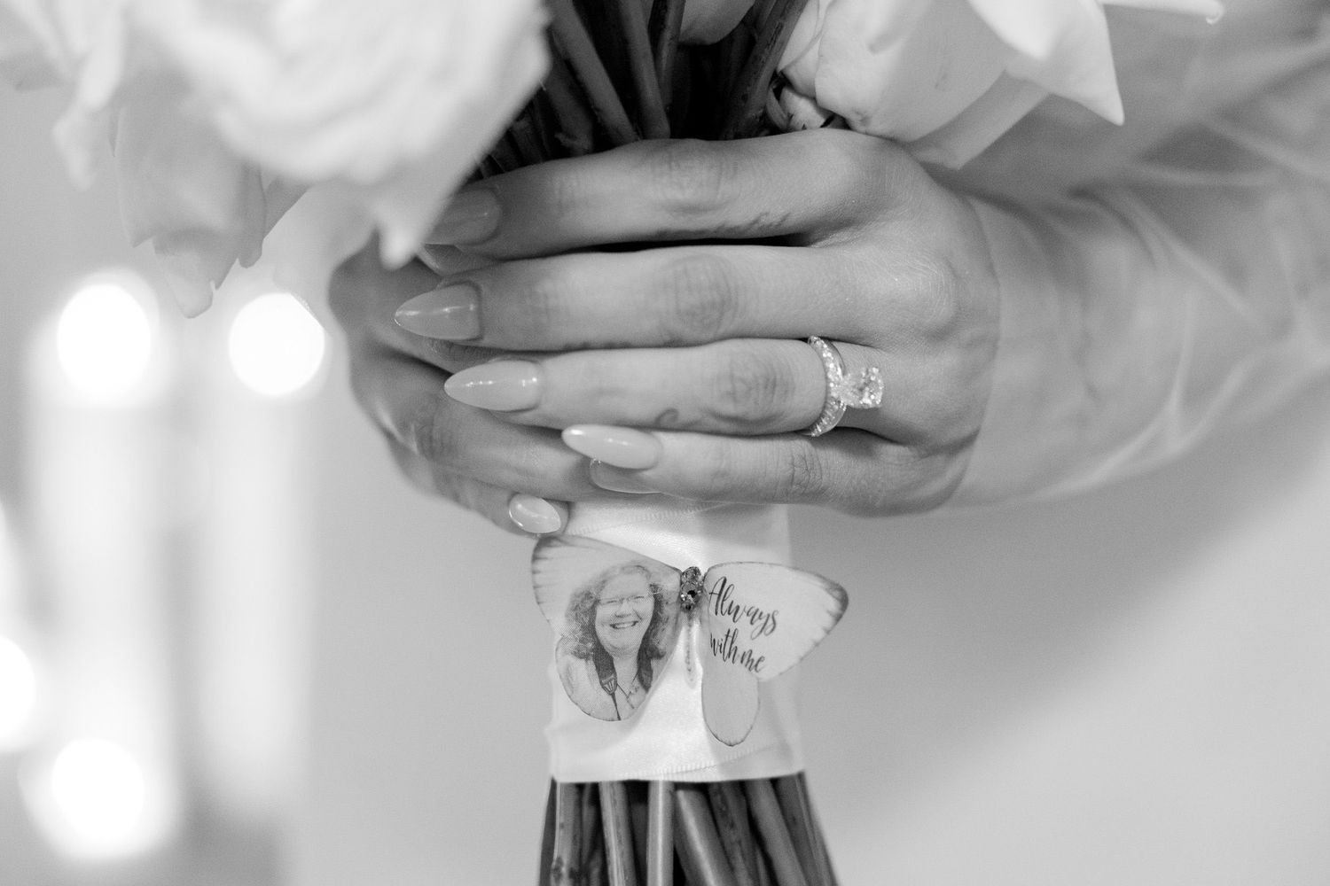 Wedding ring detail shot showcasing sparkling diamonds against soft focus background.