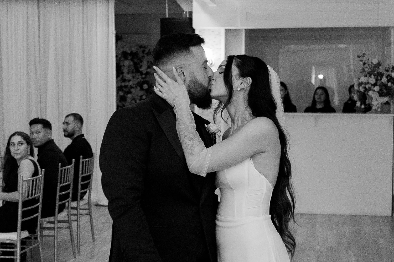 Wedding ceremony moments captured in black and white with romantic lighting.