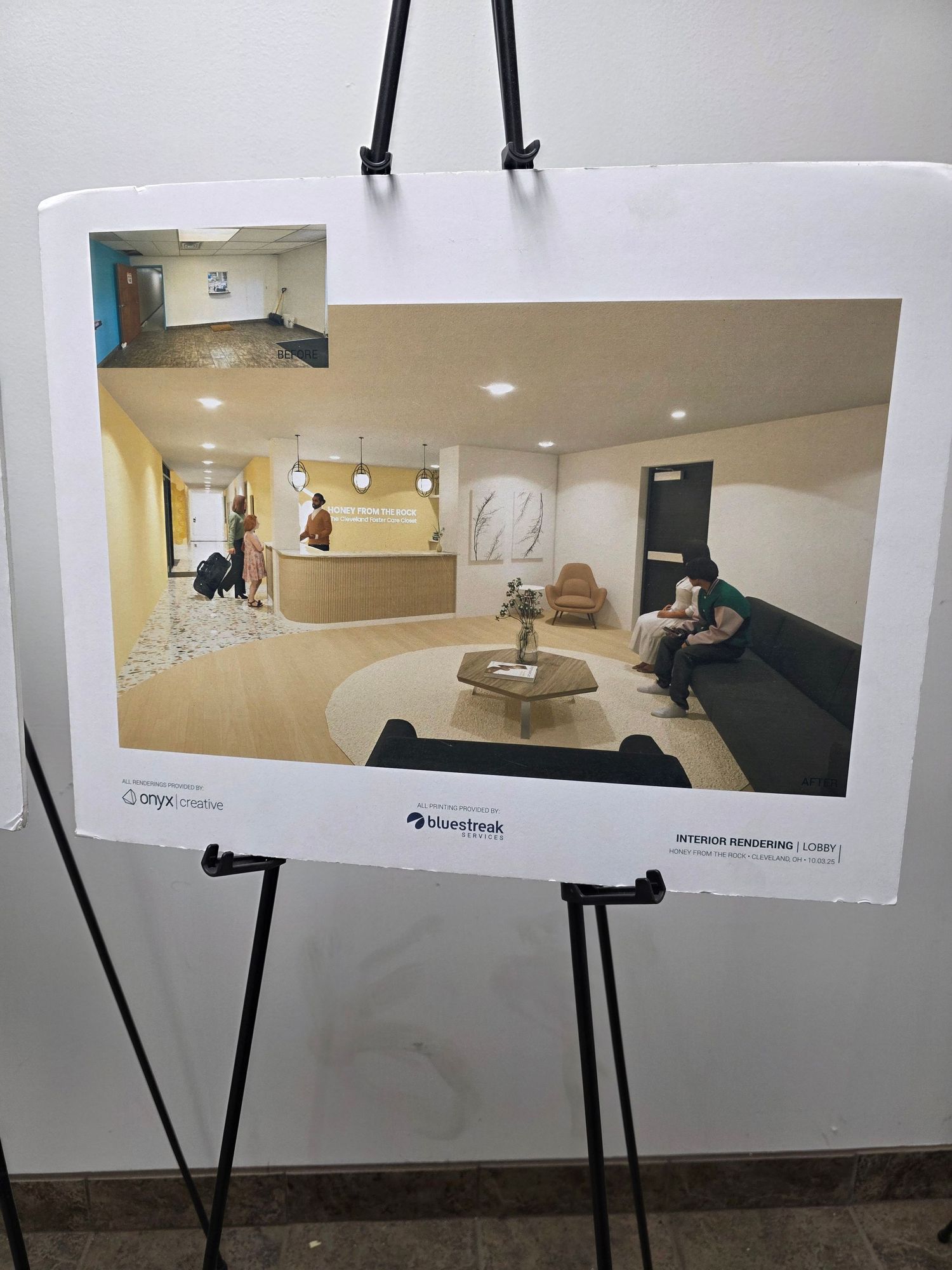 Interior design rendering displayed on an easel showing a modern lobby with reception desk and waiting area.