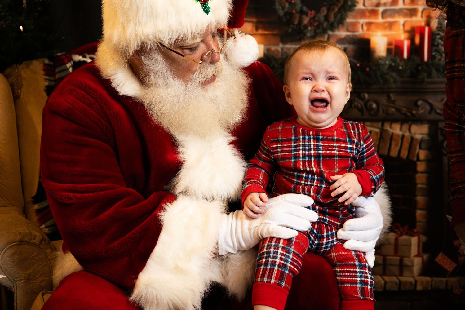 A series of photos showing a child in plaid pajamas having different emotional reactions while meeting Santa Claus.