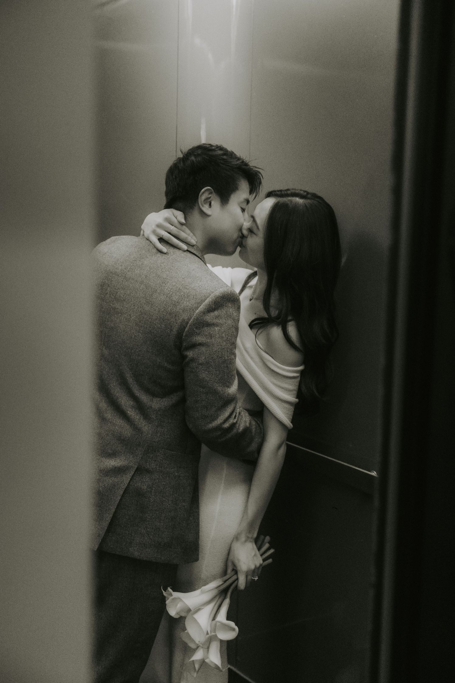 A sequence of black and white photos showing two people in an intimate moment near an elevator.