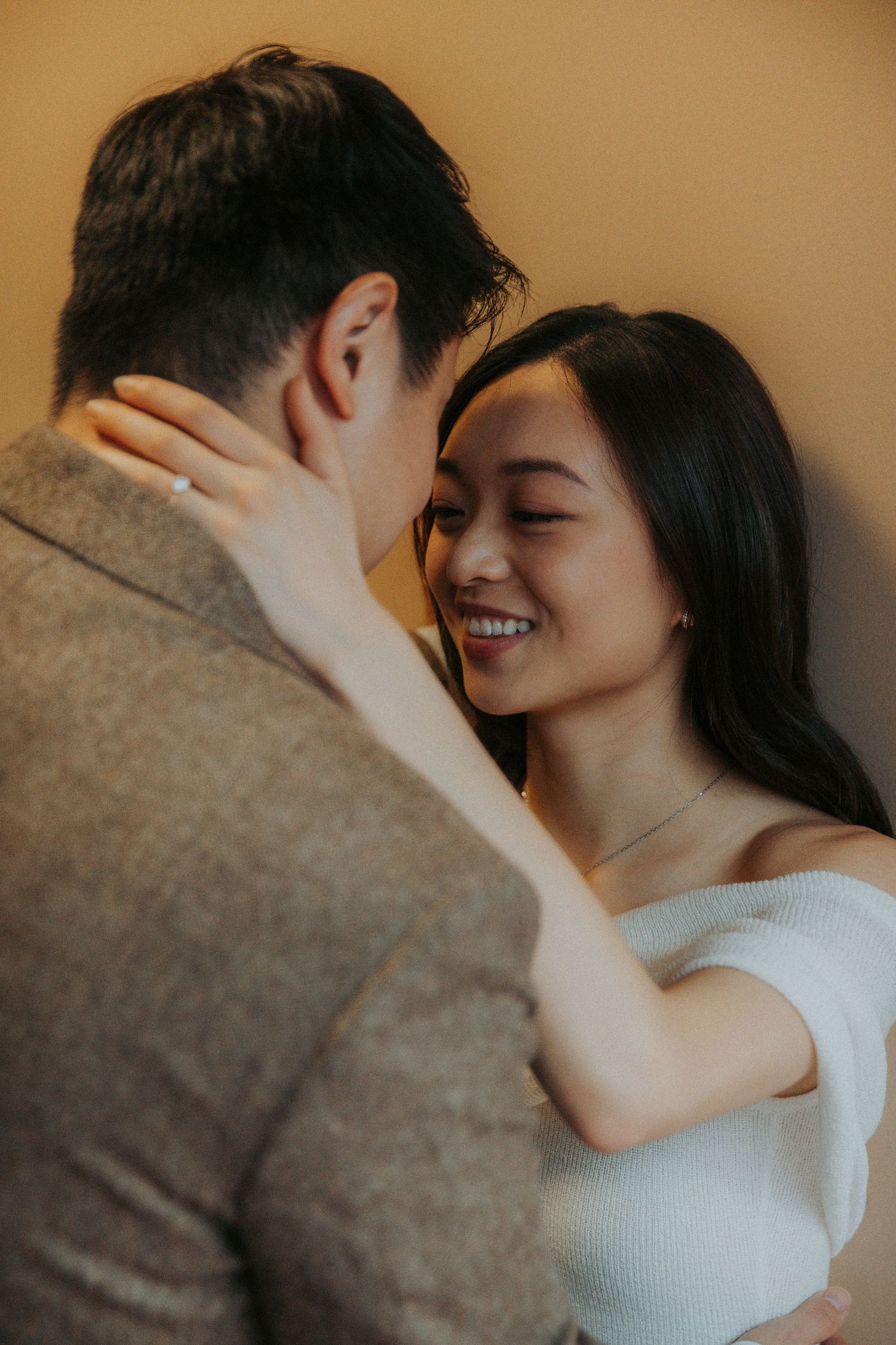A romantic couple embracing and sharing tender moments in a series of intimate photographs with warm lighting.