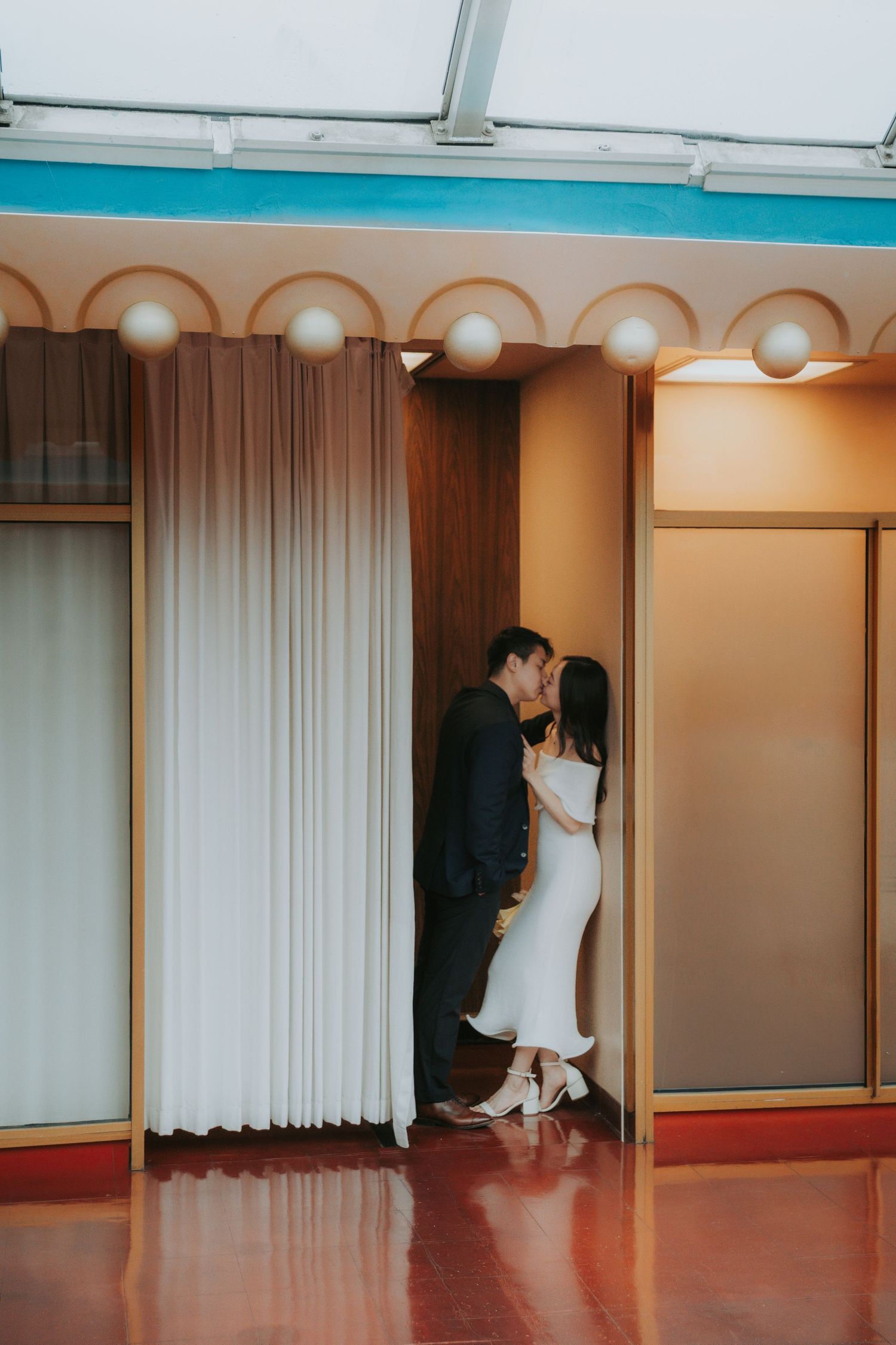 A sequence of images showing movement behind white curtains in a room with warm lighting and wooden floors.