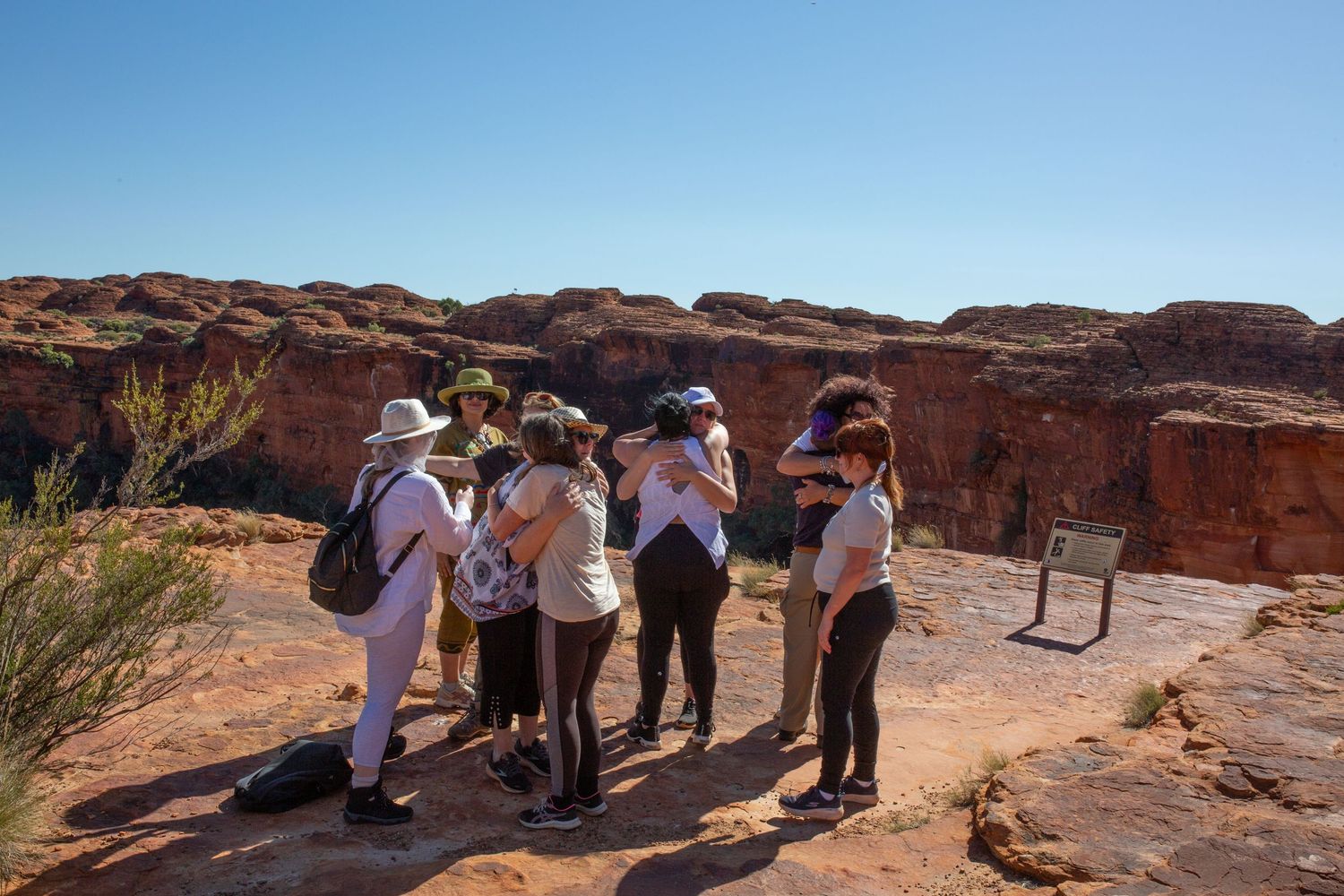 Tourists explore scenic red rock formations and hiking trails at Garden of the Gods in Colorado National Park.
