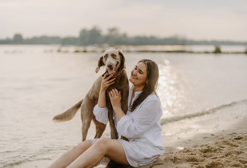 A sweet moment captured on a beach between companions enjoying nature together.