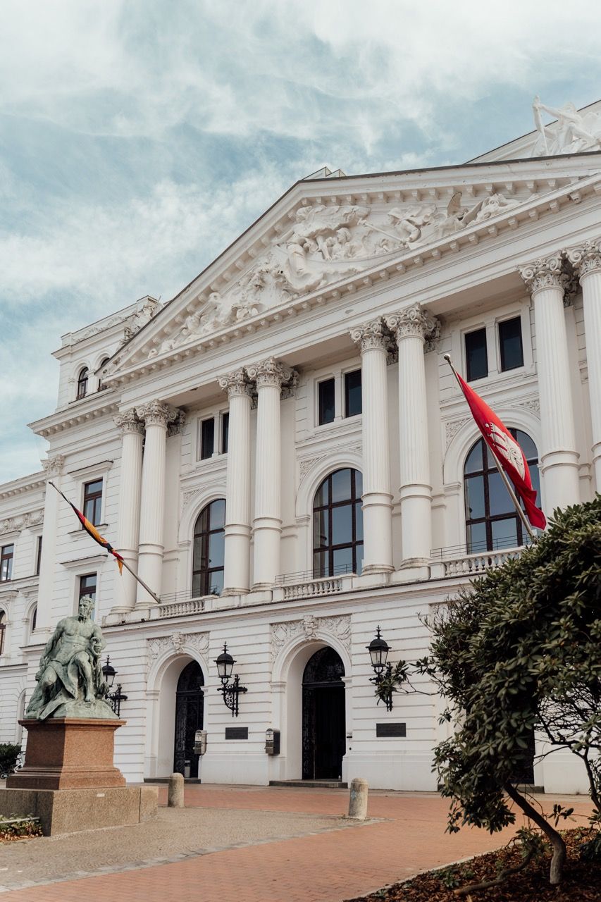 Neoclassical white government building with ornate columns and pediment in Asuncion, Paraguay shown from different angles.
