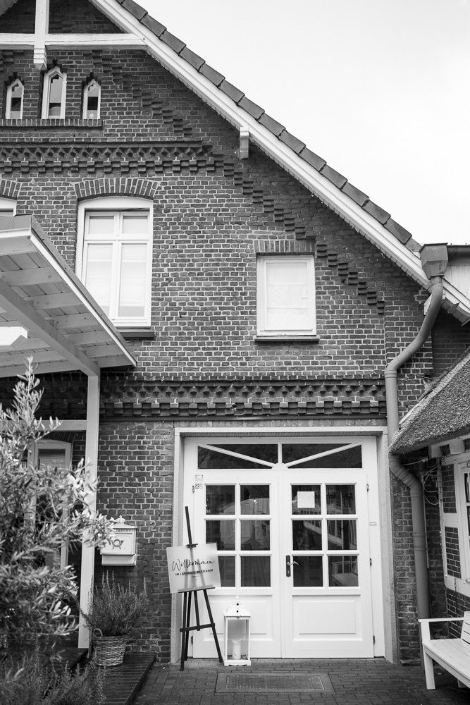 Series of traditional brick house facades with white trim windows and gabled roofs showing architectural details.