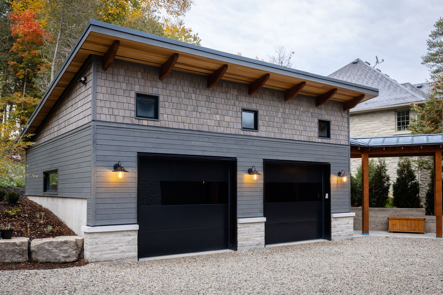 A custom garage with cedar shake wood siding.