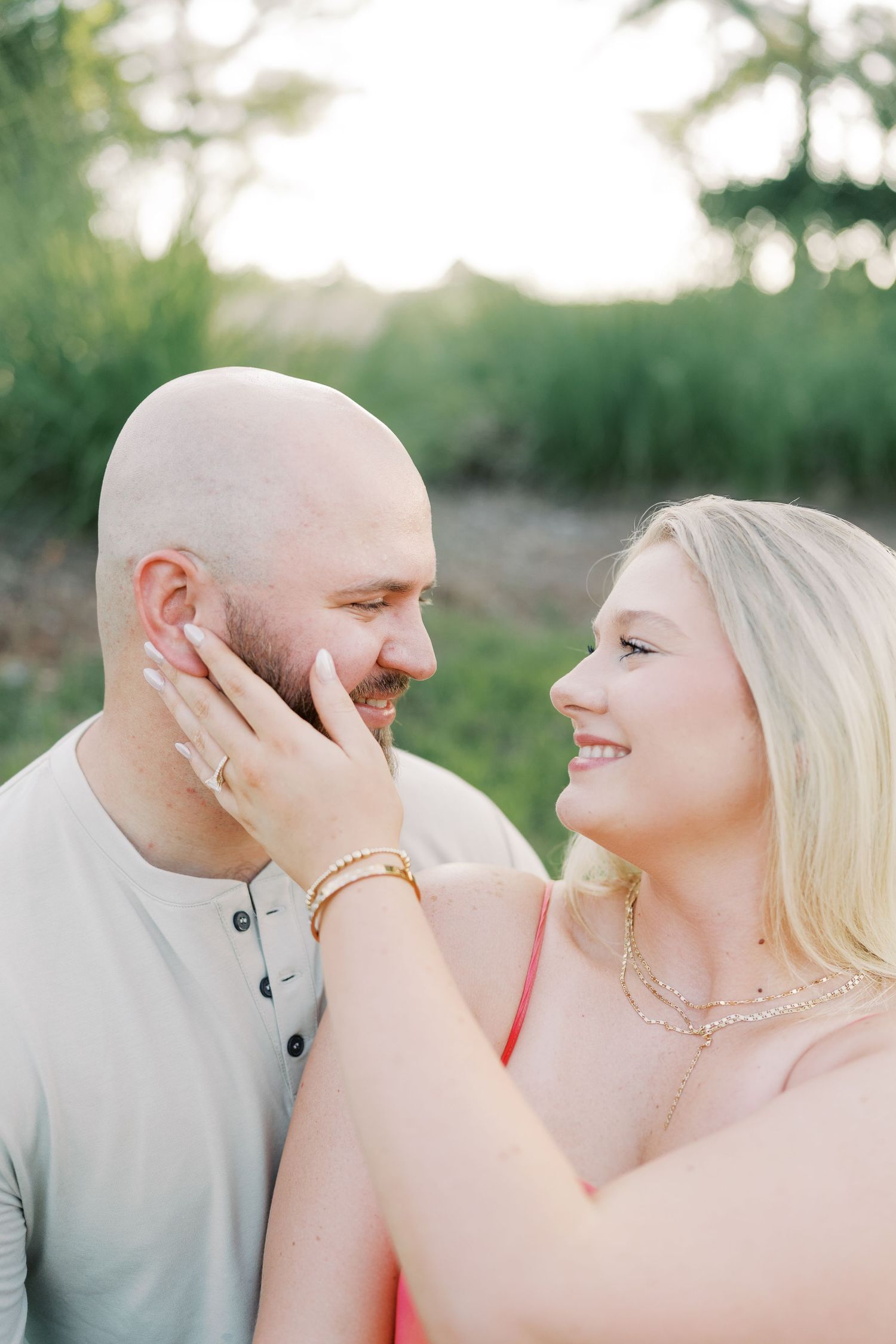 Intimate close-up portrait in natural outdoor setting with soft lighting.