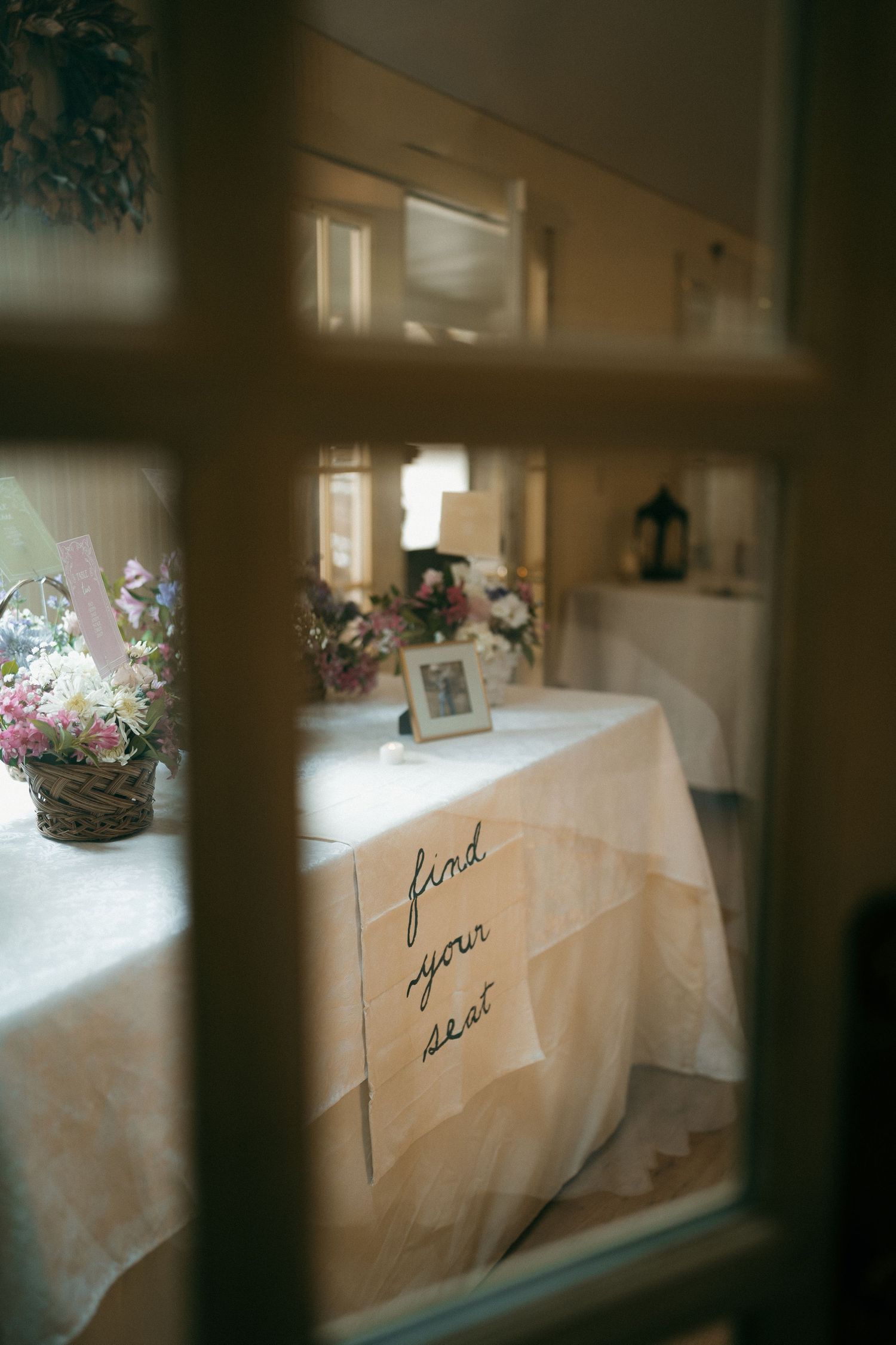Handwritten text on white tablecloths at an elegant event setting.