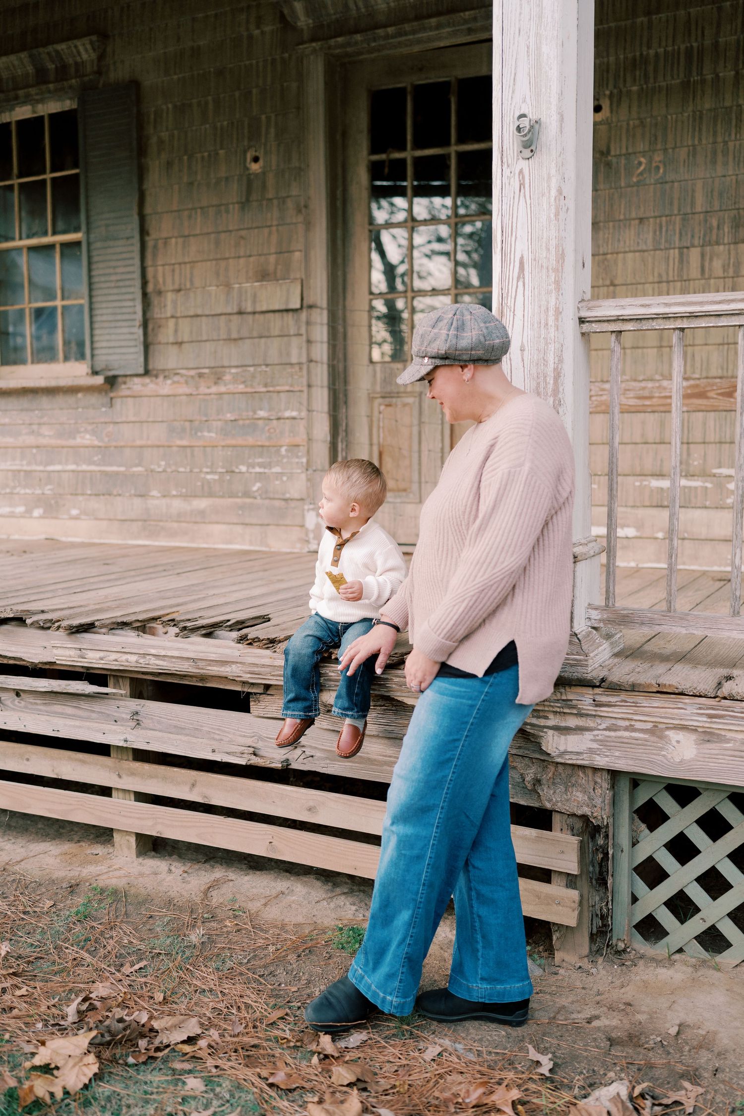 A casual moment captured on an old wooden porch with weathered siding.