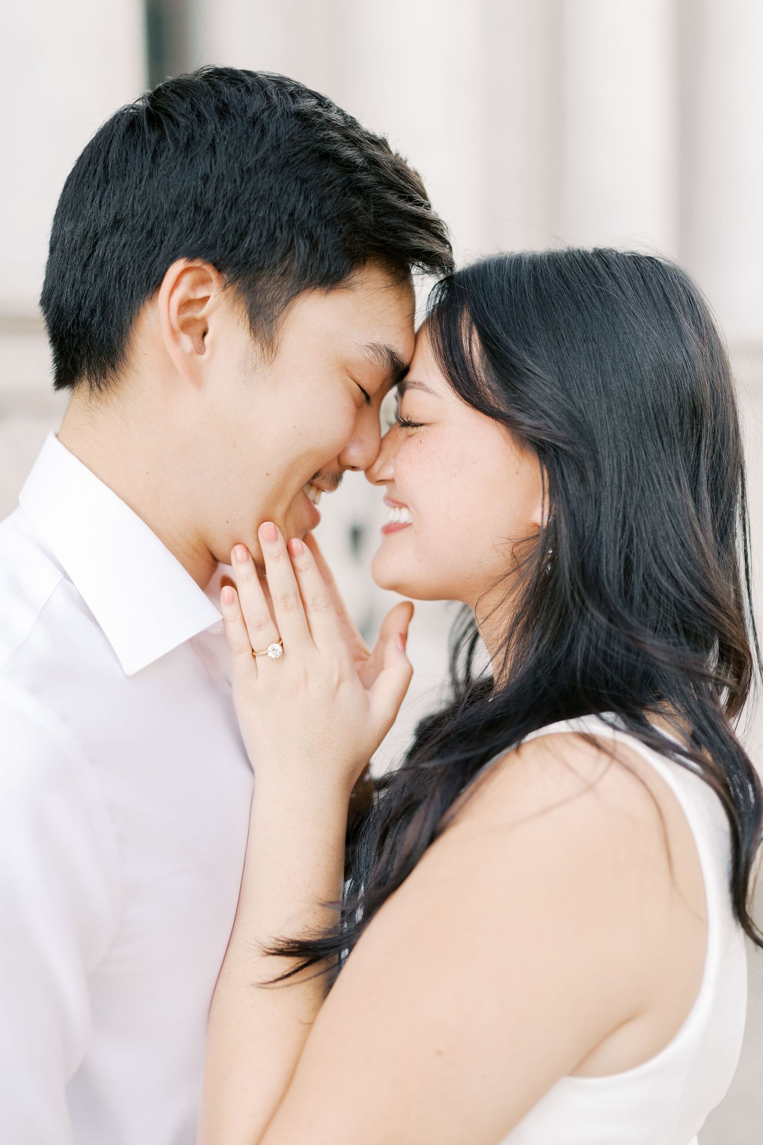 An intimate couple's portrait session showing tender moments against a bright white background.