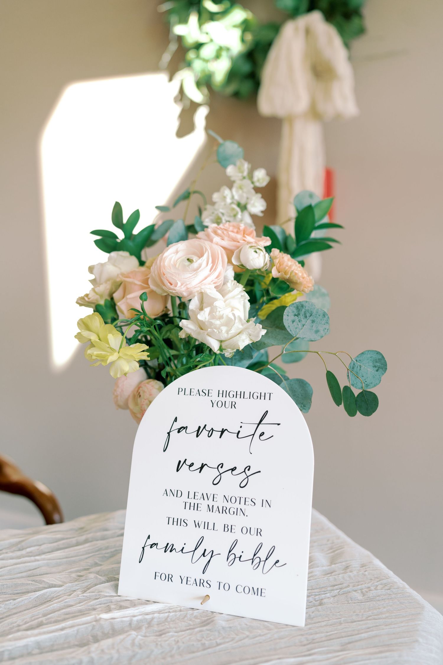 Wedding detail cards displayed with floral arrangements and elegant calligraphy.