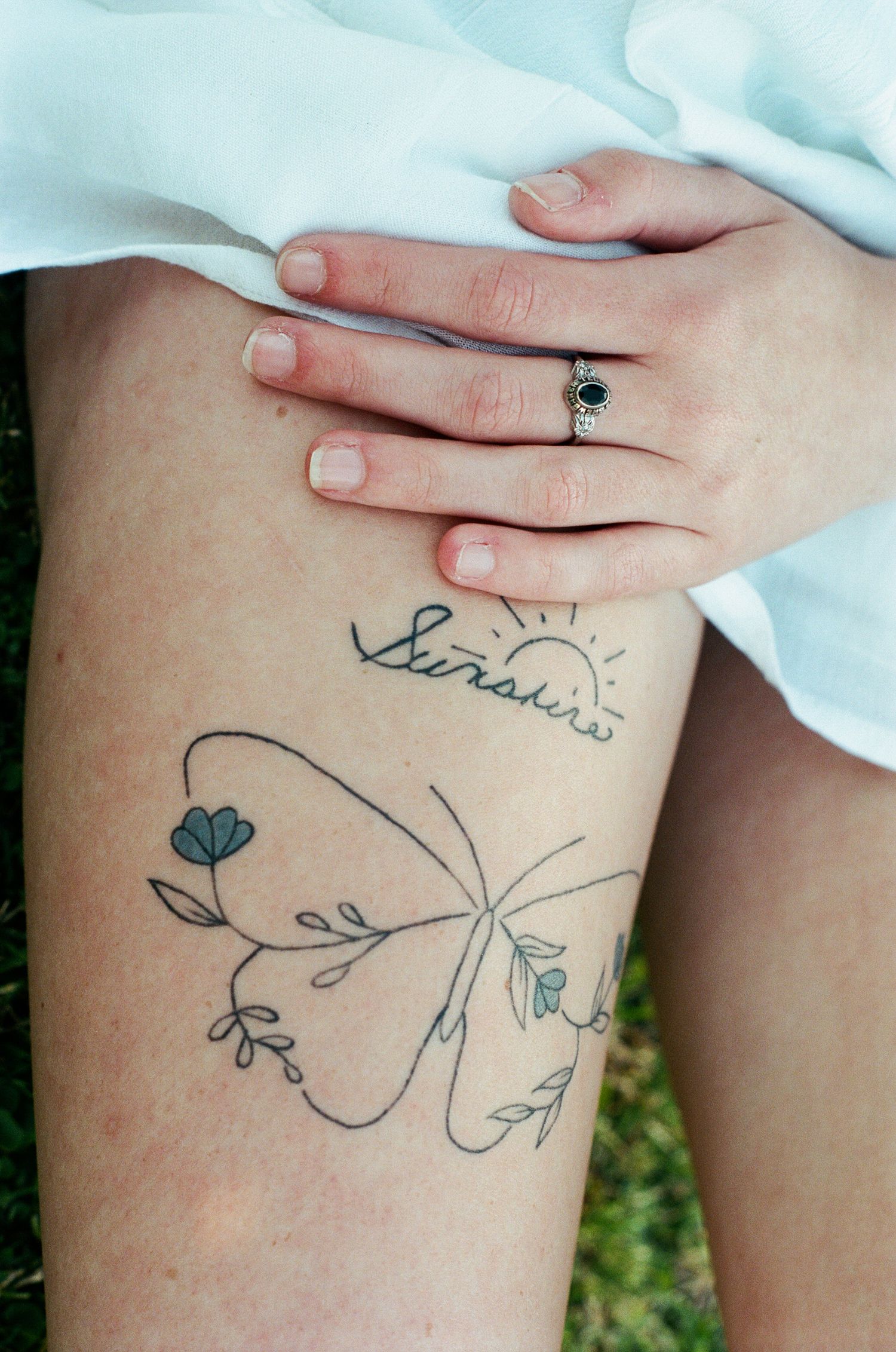 Close-up of delicate floral tattoo design on skin.