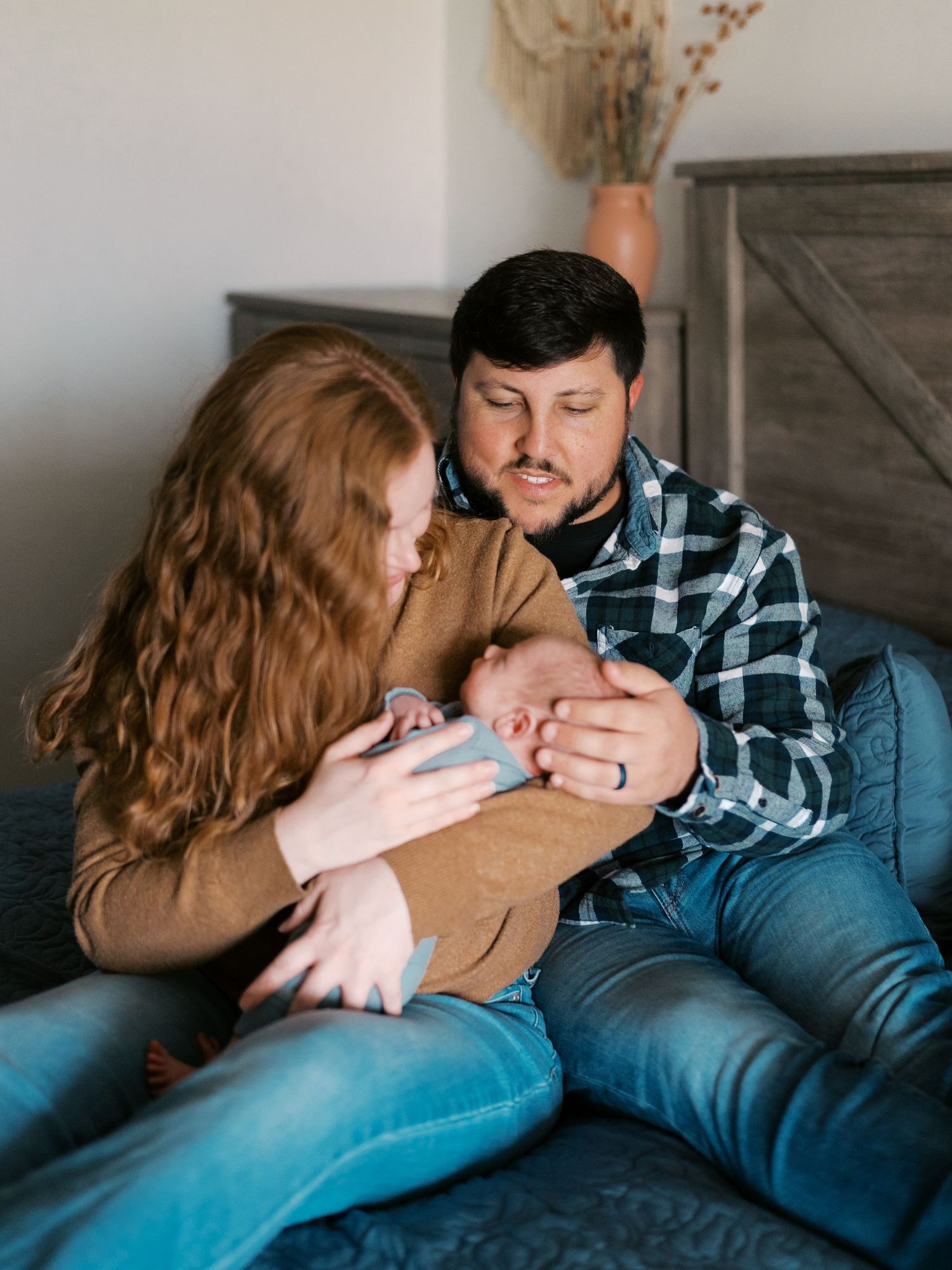 Intimate family moment on couch showing tender interaction in natural light.