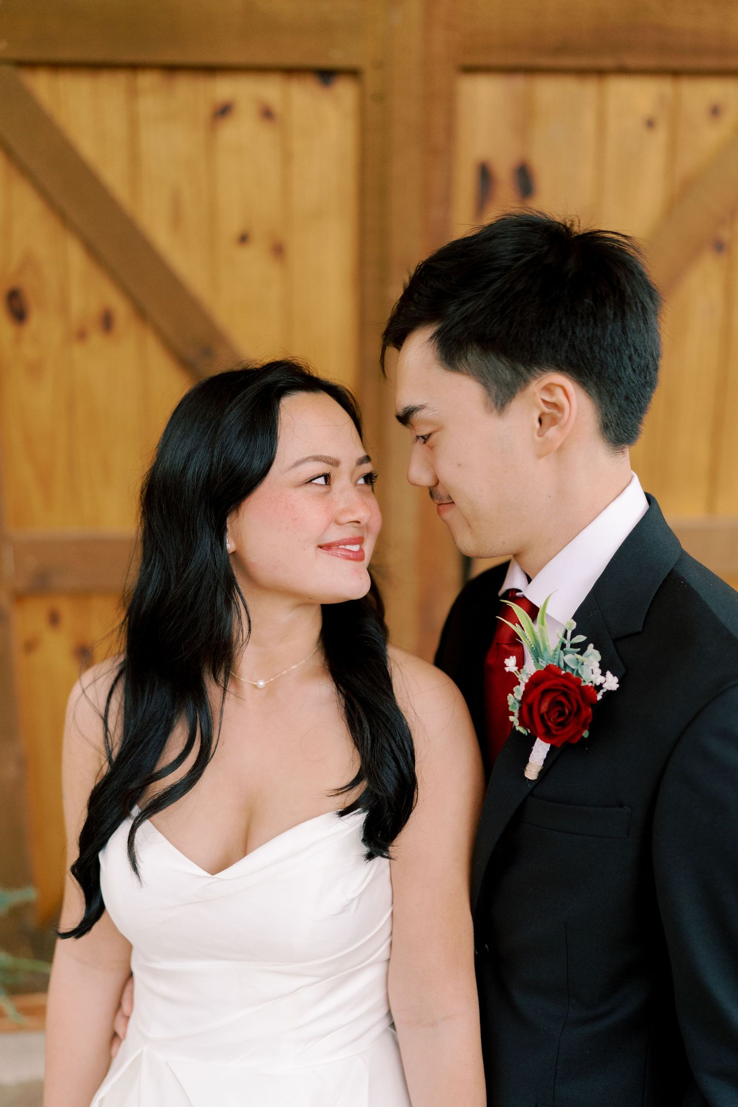 A romantic wedding photoshoot sequence showing tender moments between a couple in front of a wooden backdrop.