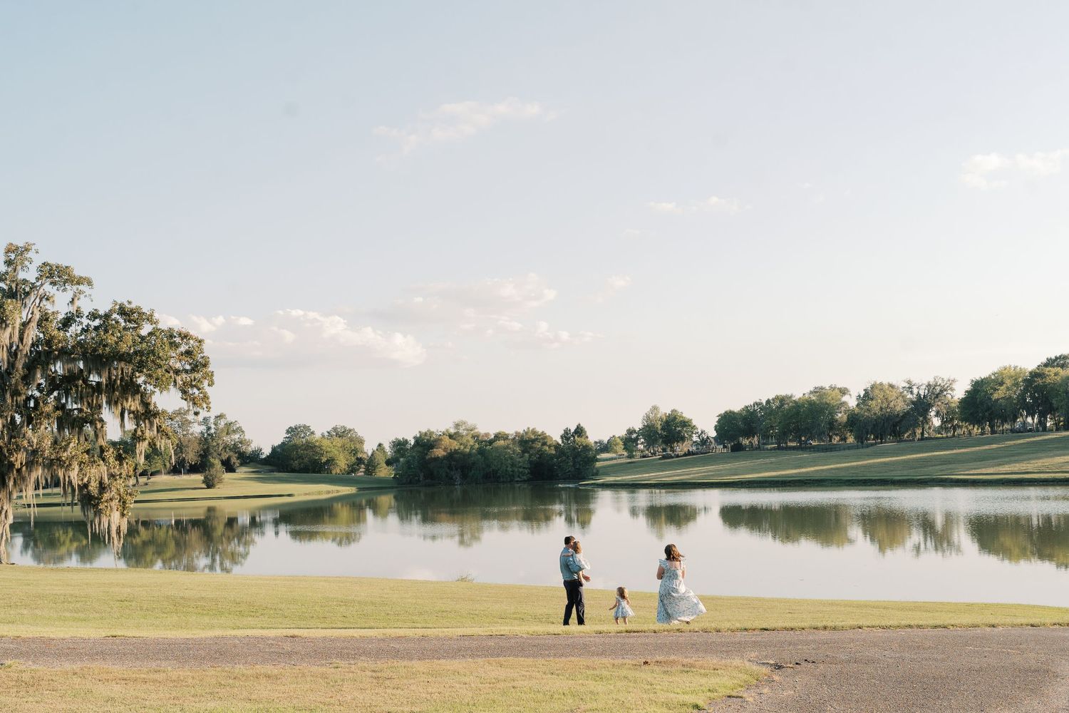 Scenic lakeside view with people enjoying outdoor activities in the distance.