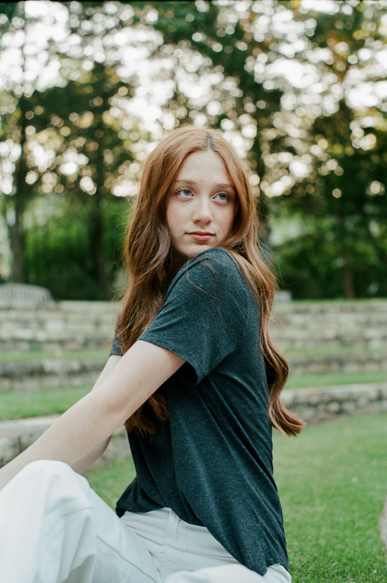 Dynamic poses captured in a grassy outdoor setting during golden hour.