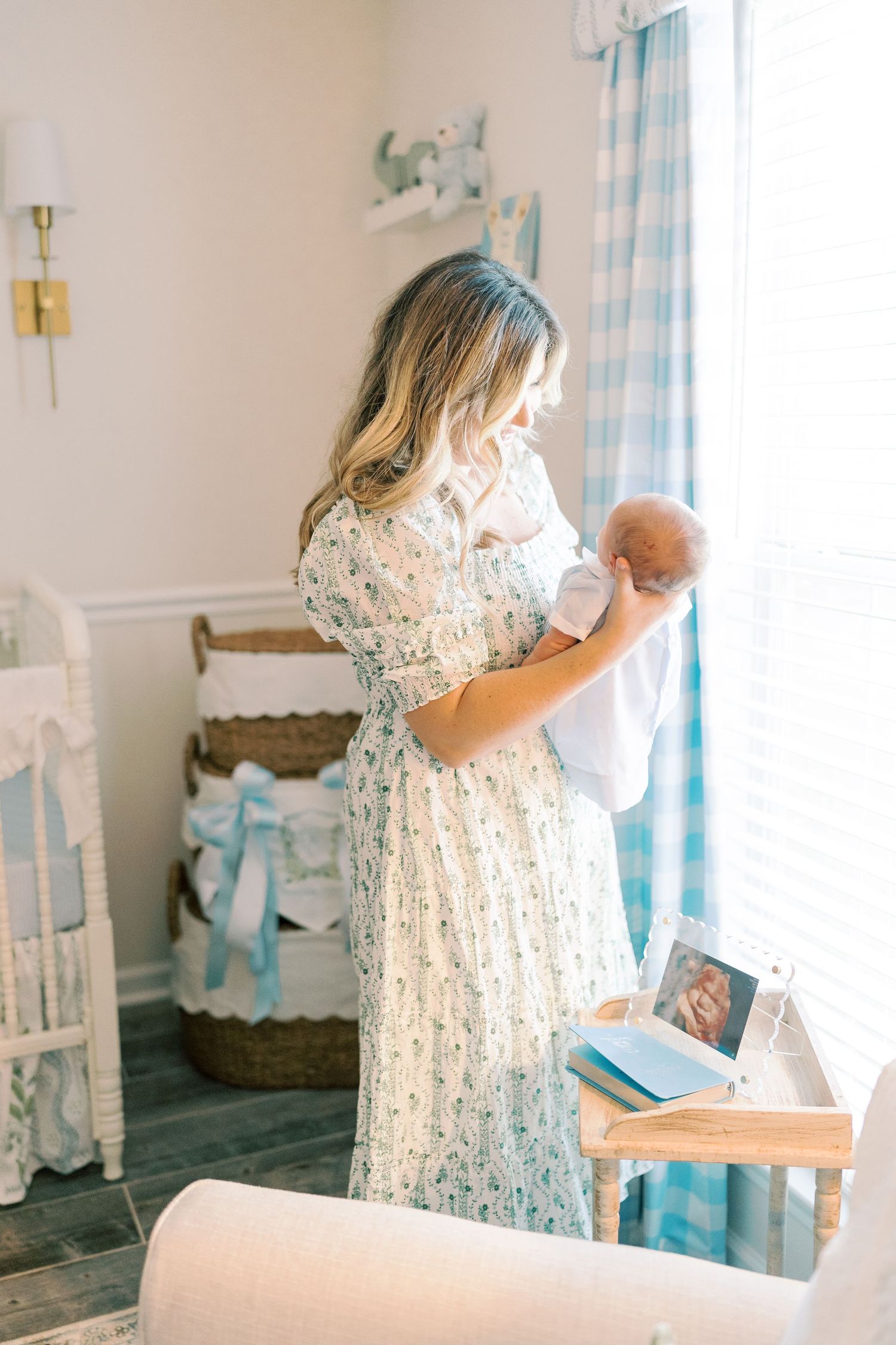 Light-filled nursery room with delicate decor and blue checkered curtains.
