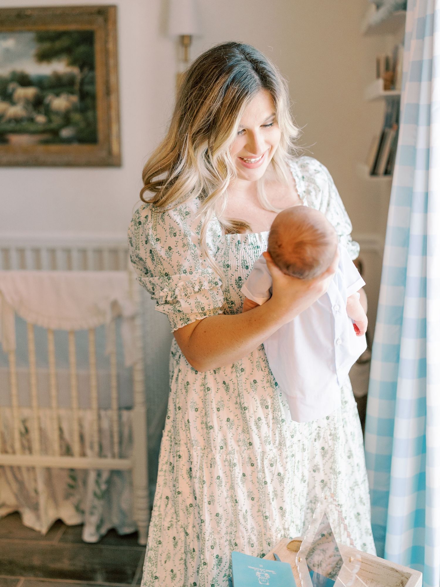 Soft and dreamy nursery scene with floral dress and white crib details.