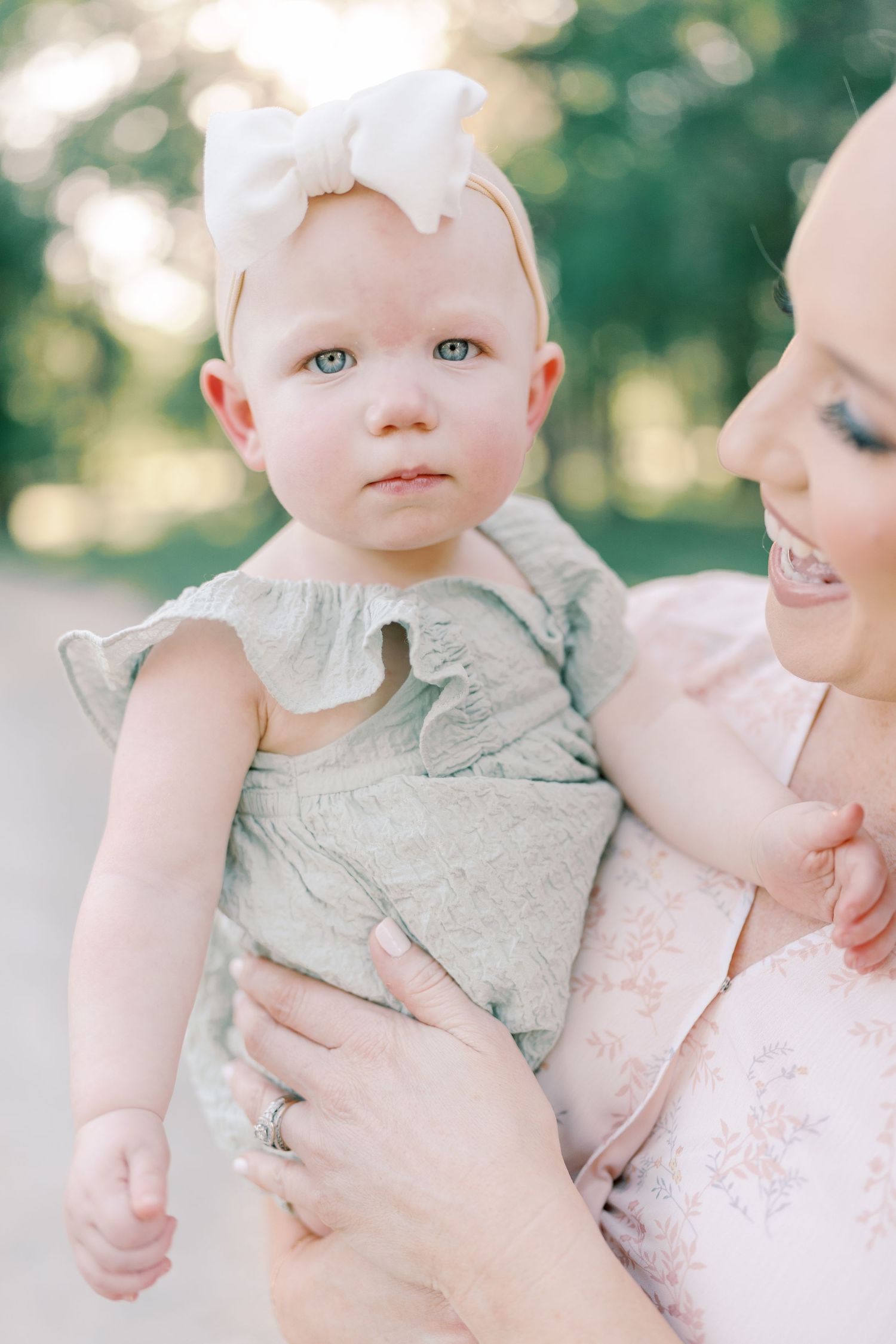A tender moment captured in soft natural lighting showing gentle interaction between parent and infant.