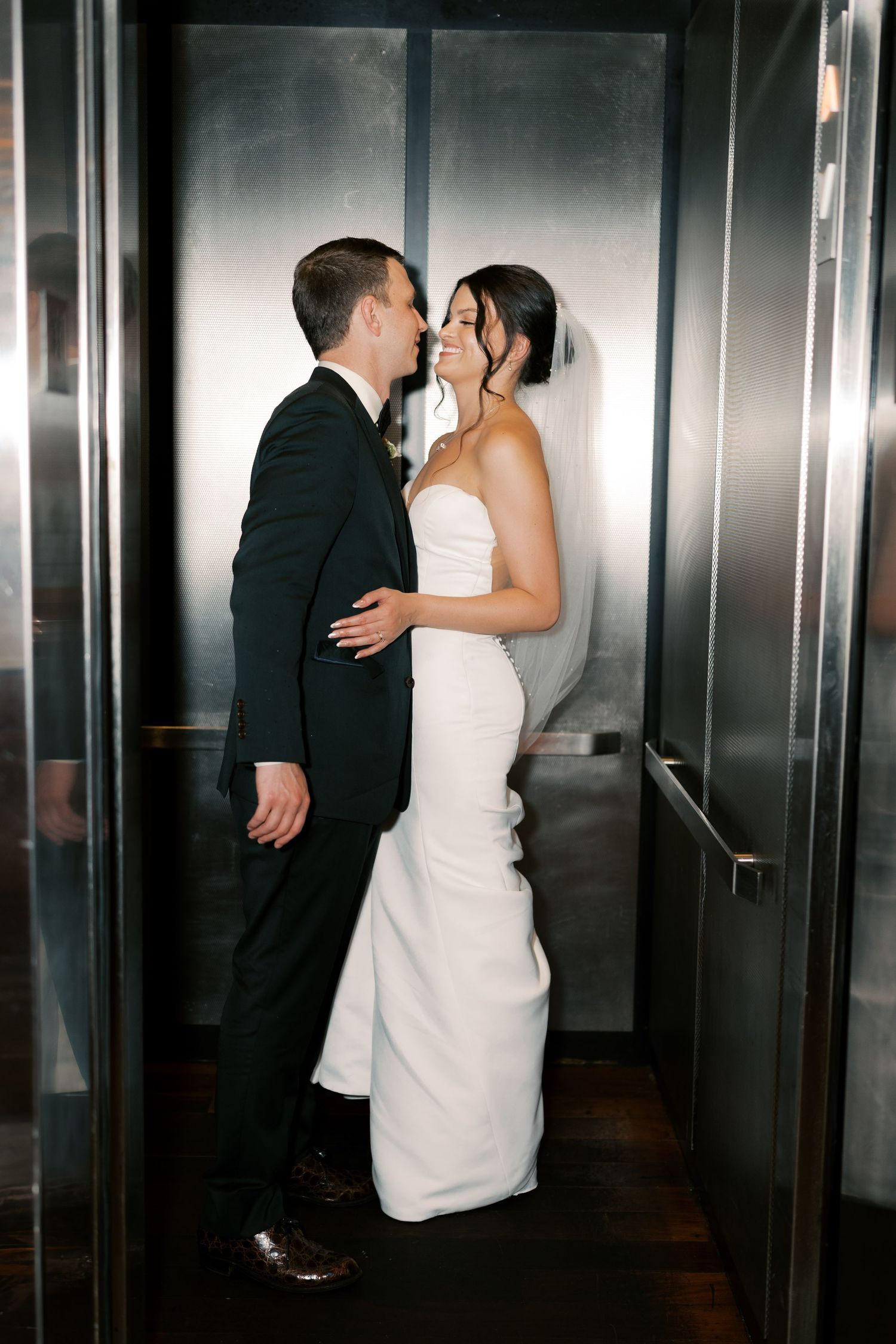 Romantic sequence of couple sharing intimate moments in a modern elevator setting.