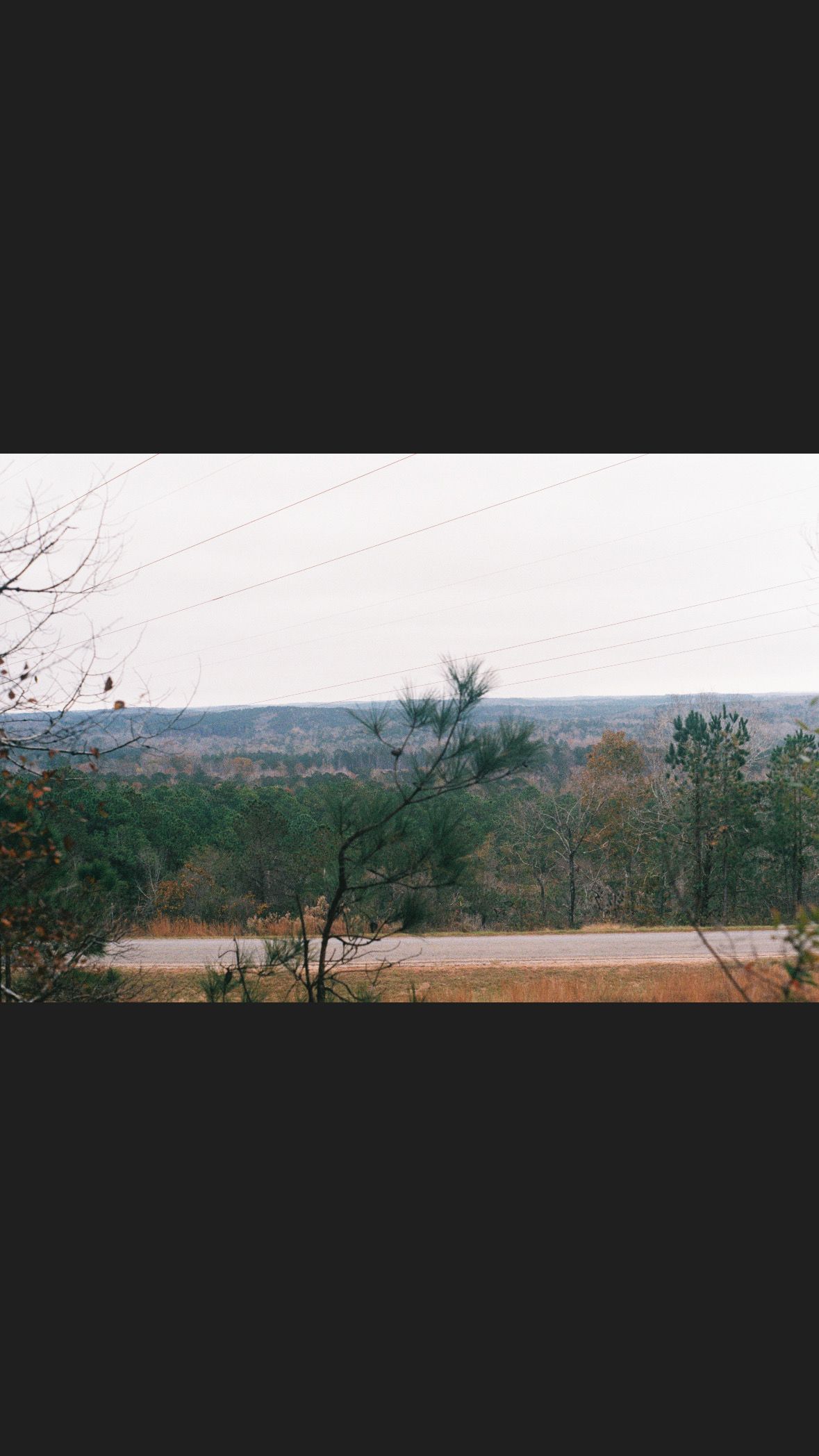 Scenic landscape view of distant hills and water.