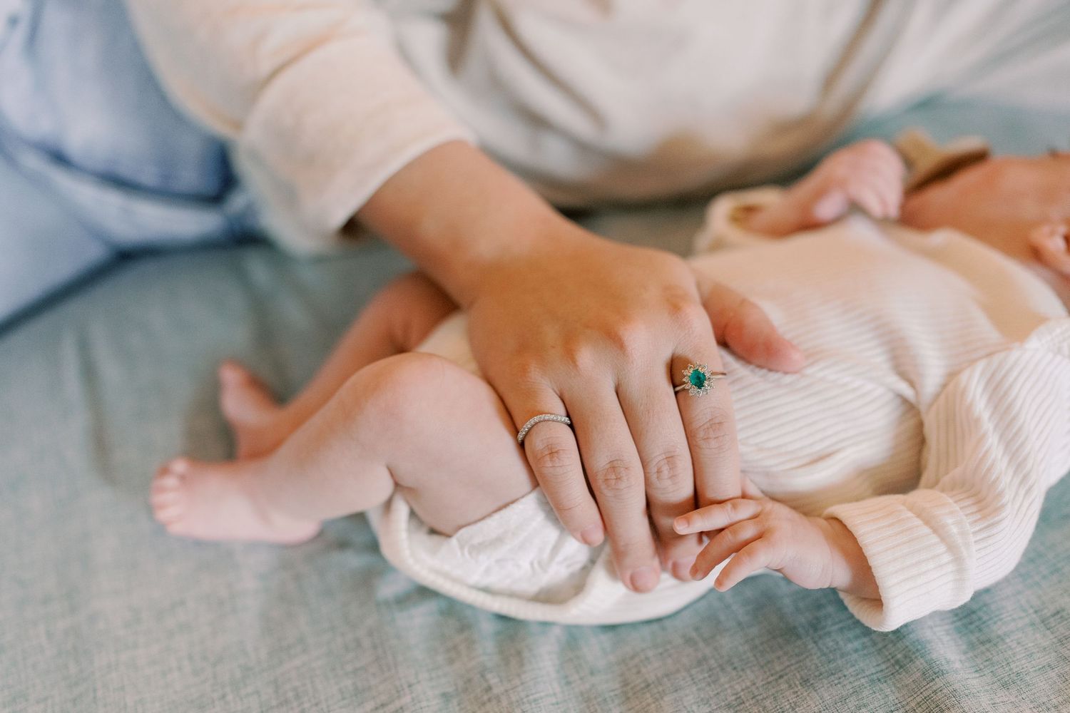 Delicate hands and fabric details in soft natural lighting.