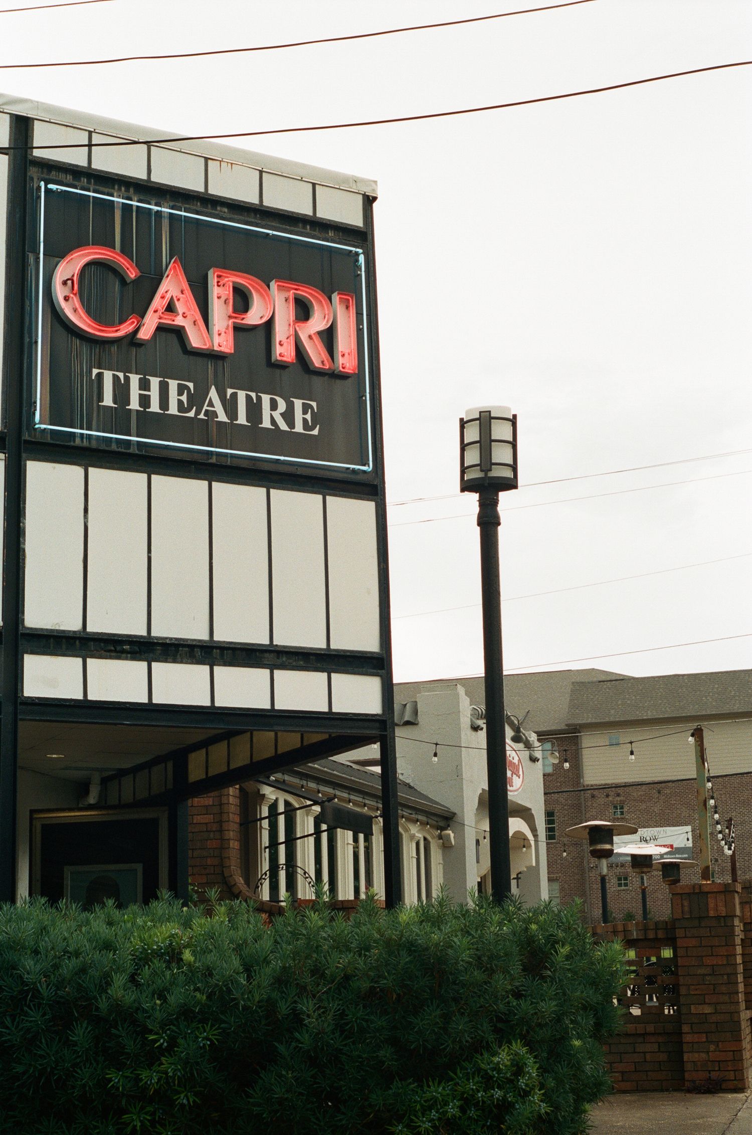 Capri Theatre sign displayed on a commercial building exterior.