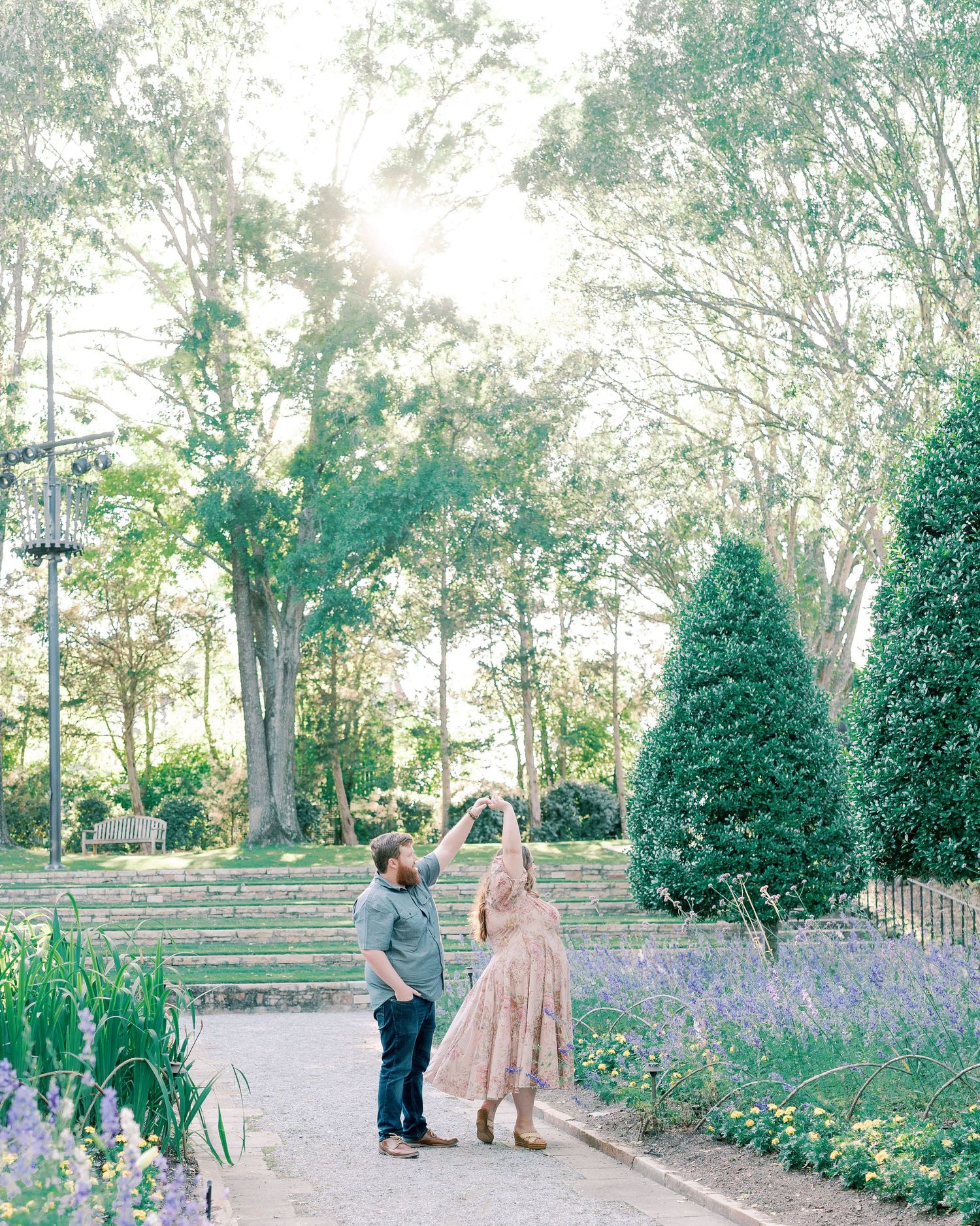 Wide garden landscape shots showing a couple among manicured trees and purple flowers.
