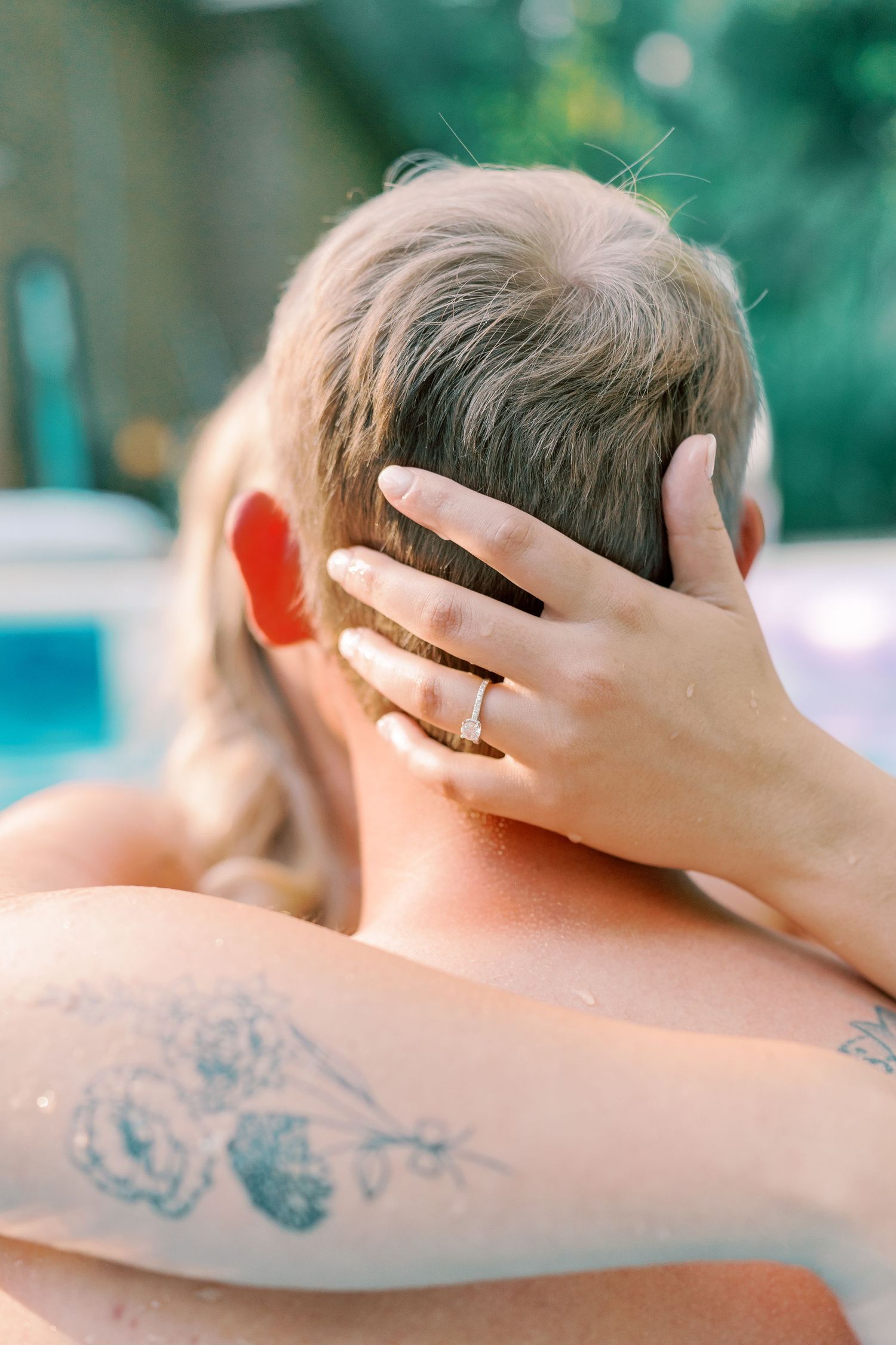 Close-up view of a tattoo on someone's back with a gentle hand caressing the skin.