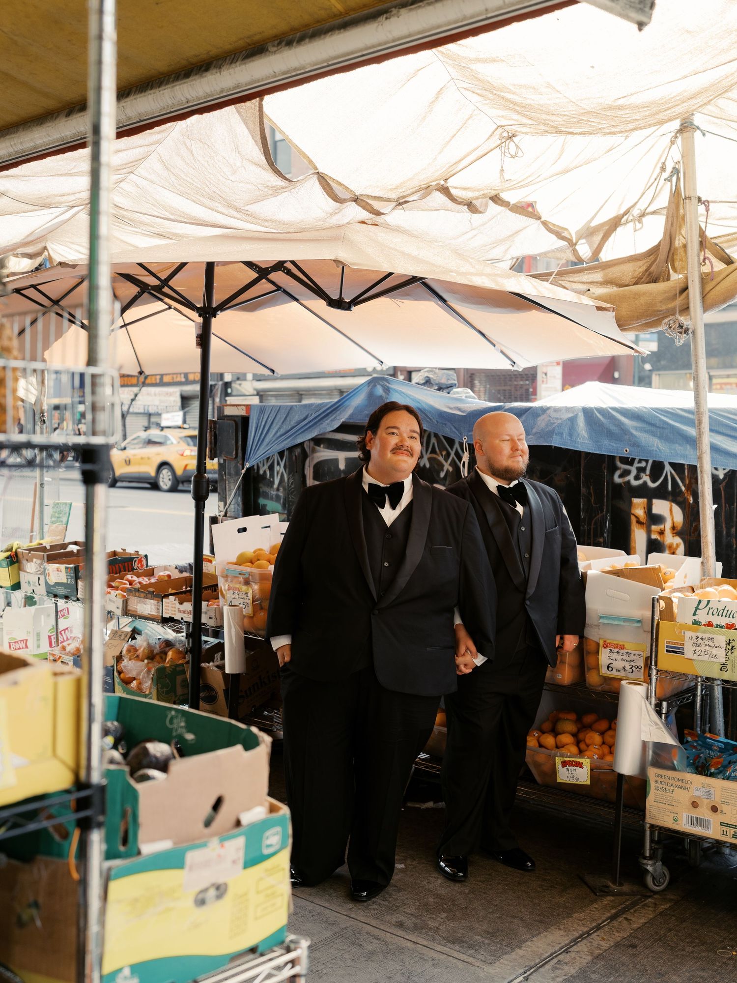 Outdoor market stalls with white canopy tents lined up in a row.