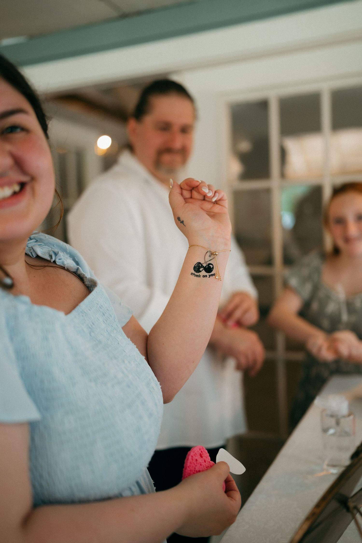 Wedding guests laugh and celebrate during the reception festivities.