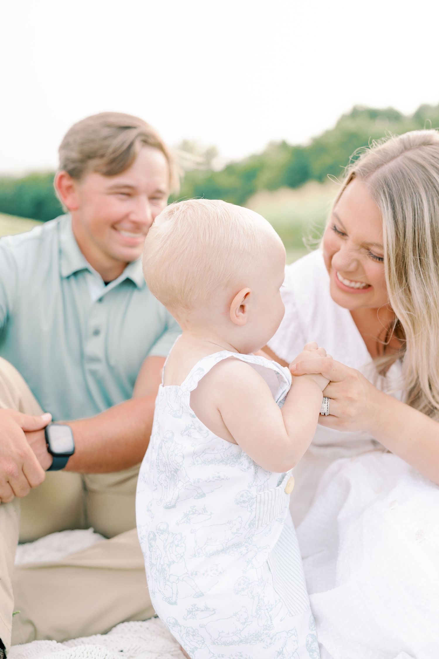 Intimate family portraits showing joyful moments and laughter in natural outdoor lighting.