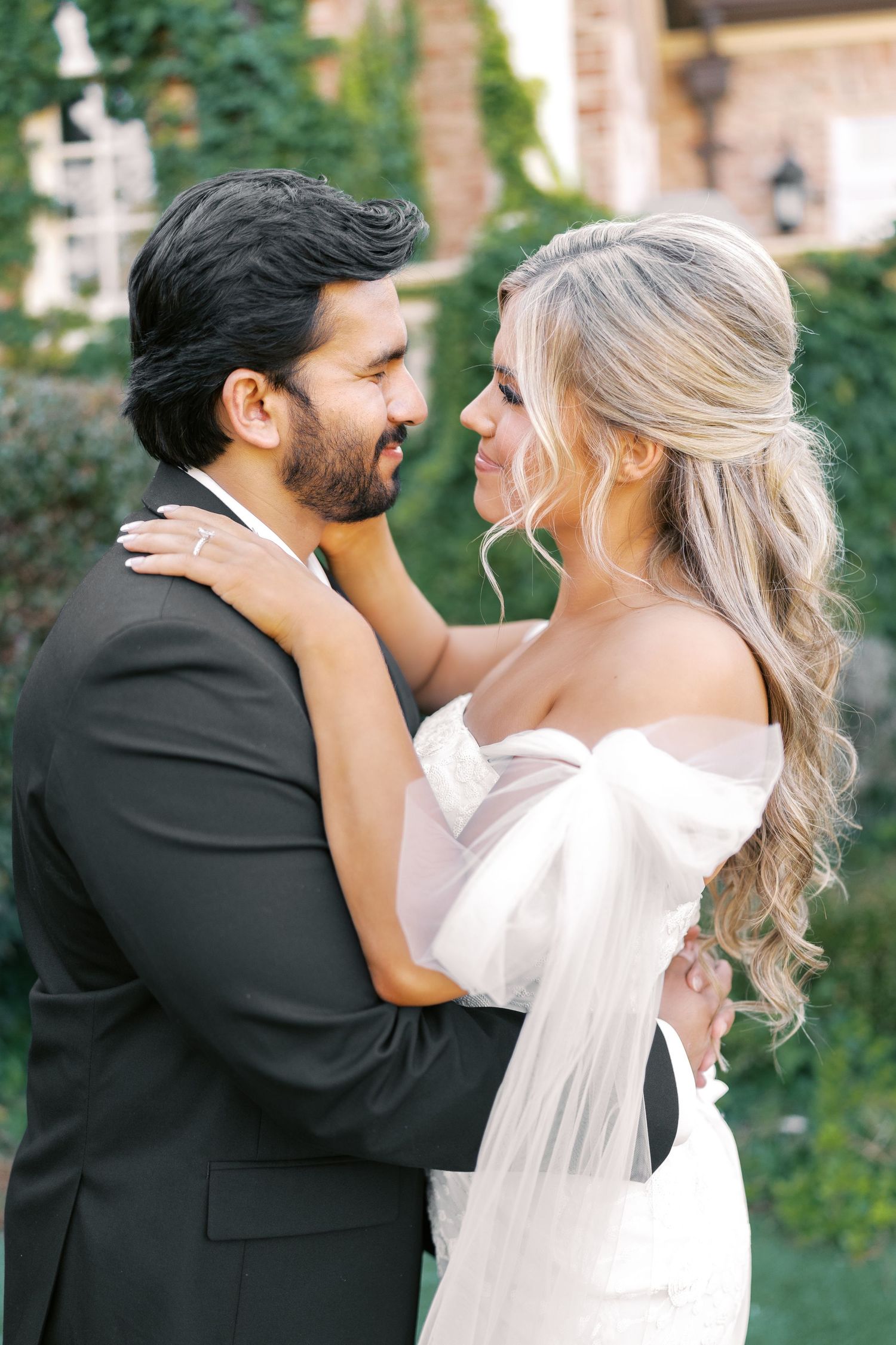 Joyful wedding couple shares intimate laughs during outdoor portrait session.