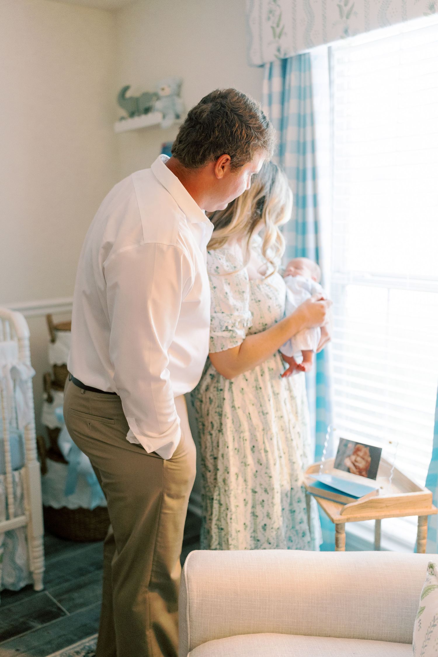 Intimate family moment captured in a beautifully decorated nursery.