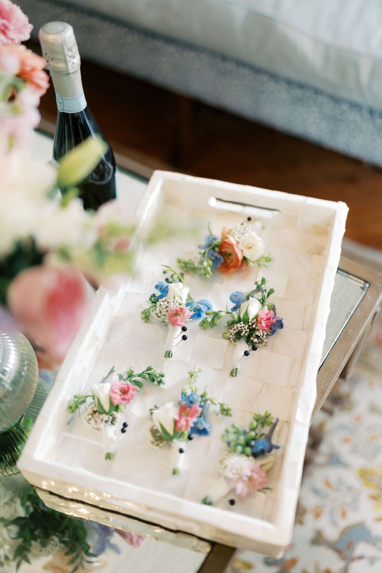 White serving tray decorated with delicate pastel flowers and greenery.