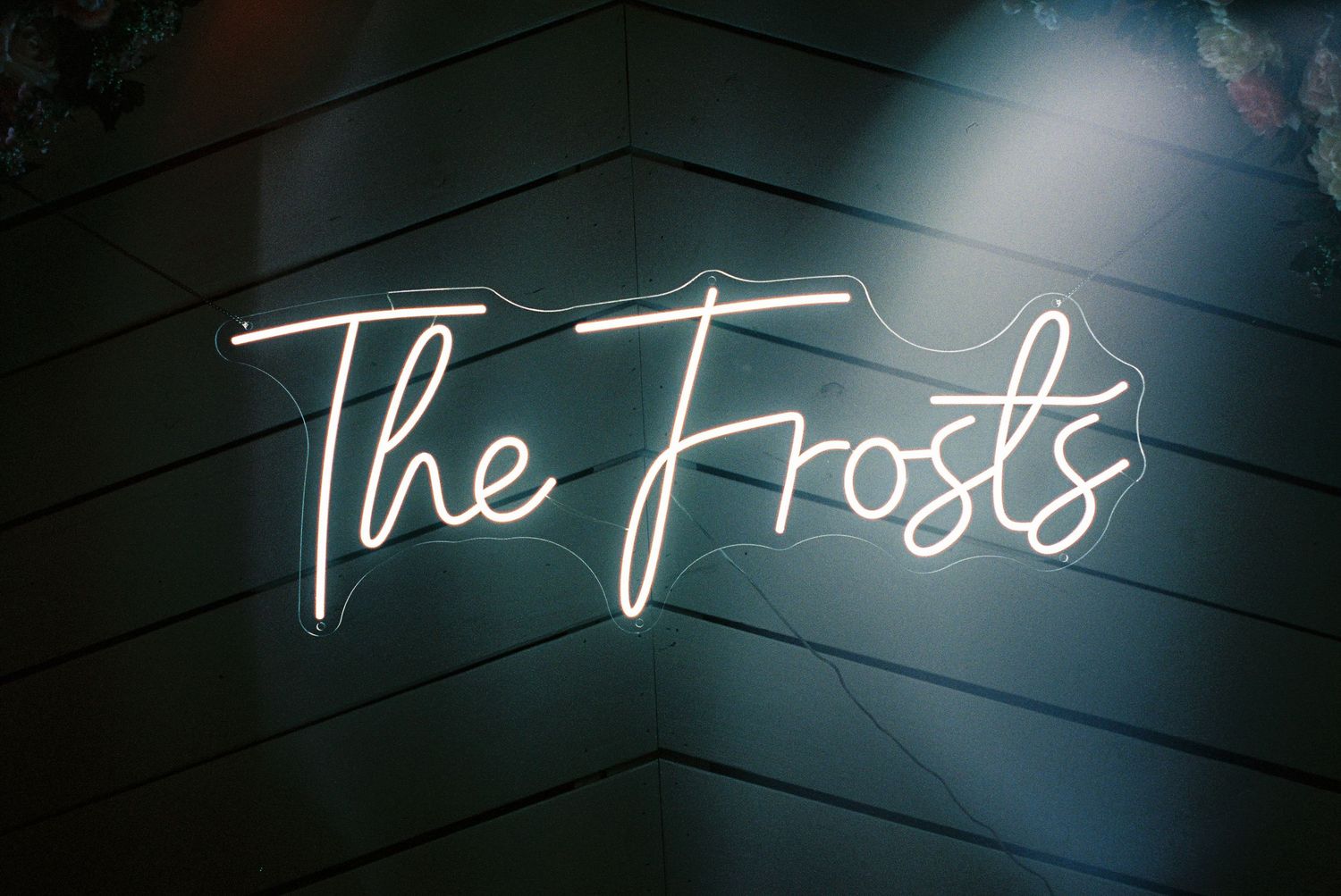 Illuminated neon text sign glowing in the dark.