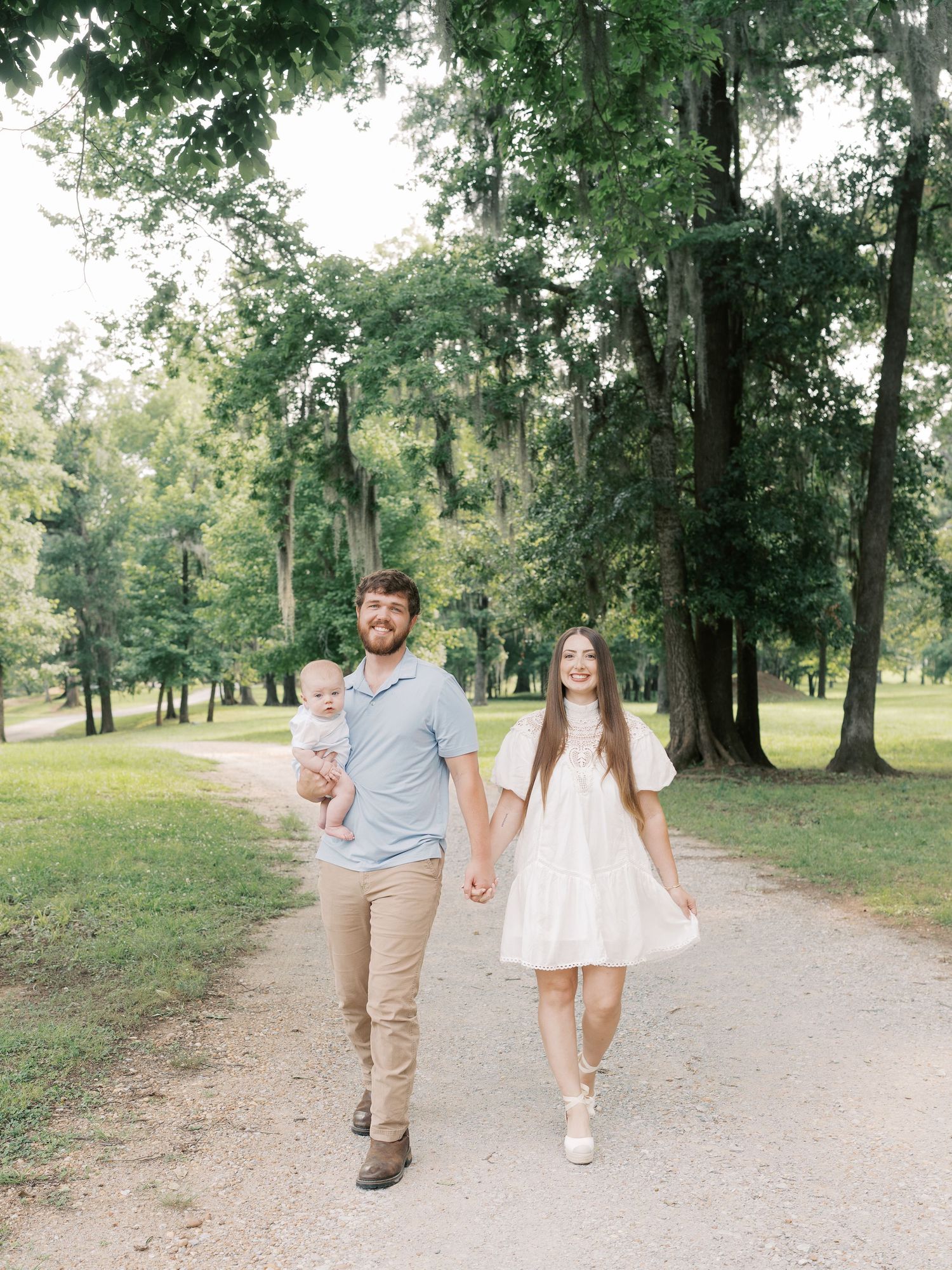 A family enjoys quality time together while walking on a scenic park trail.