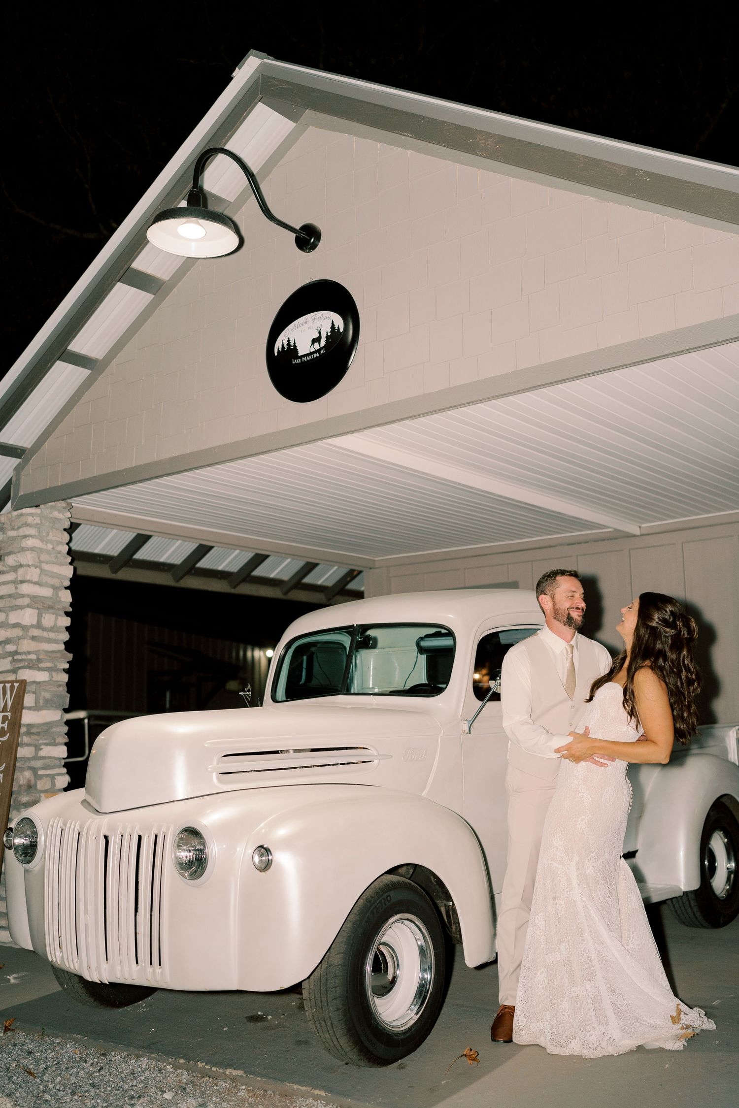 Classic white vintage car parked under covered area for wedding getaway.