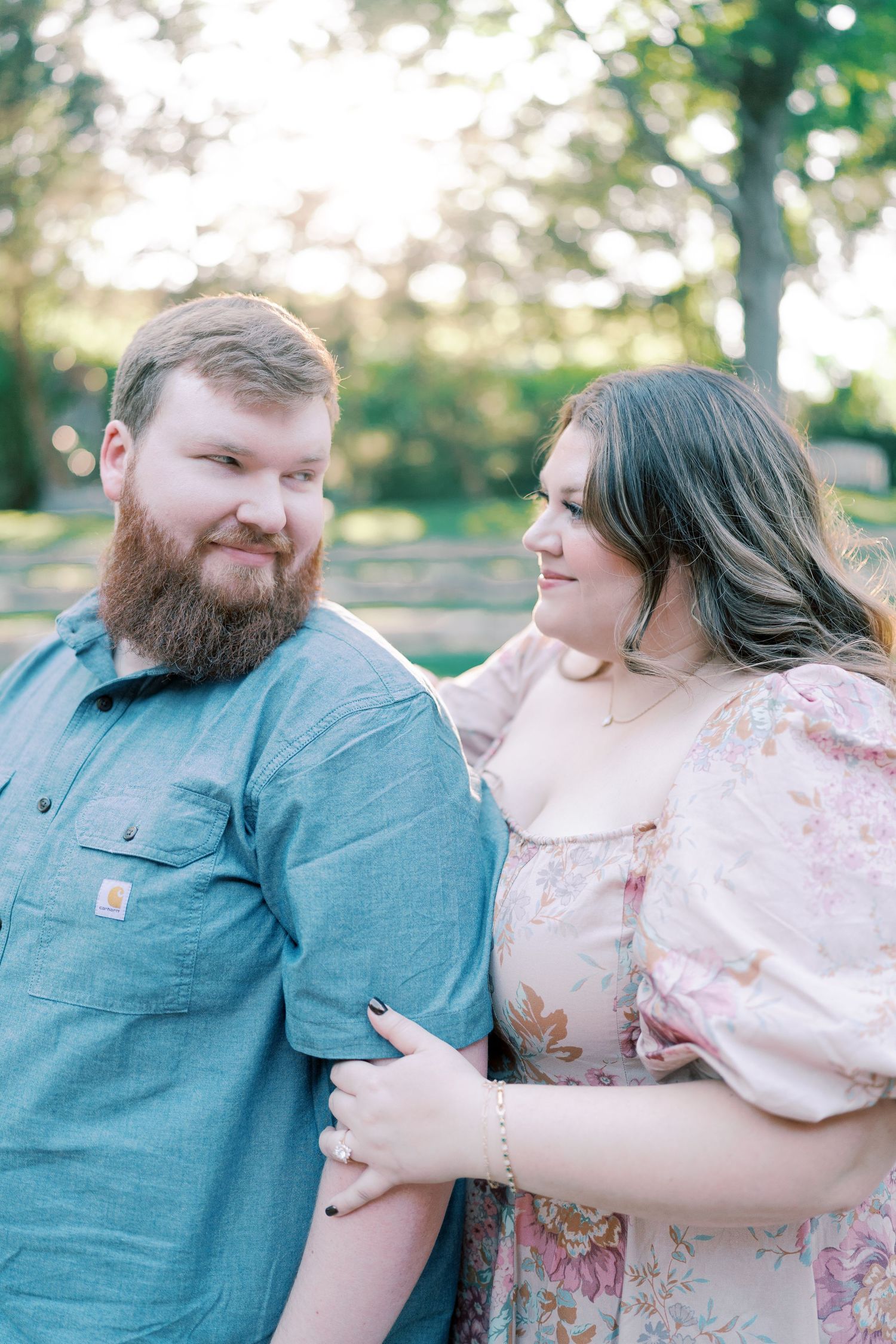 Couple shares intimate moments while sitting together in casual outdoor setting.