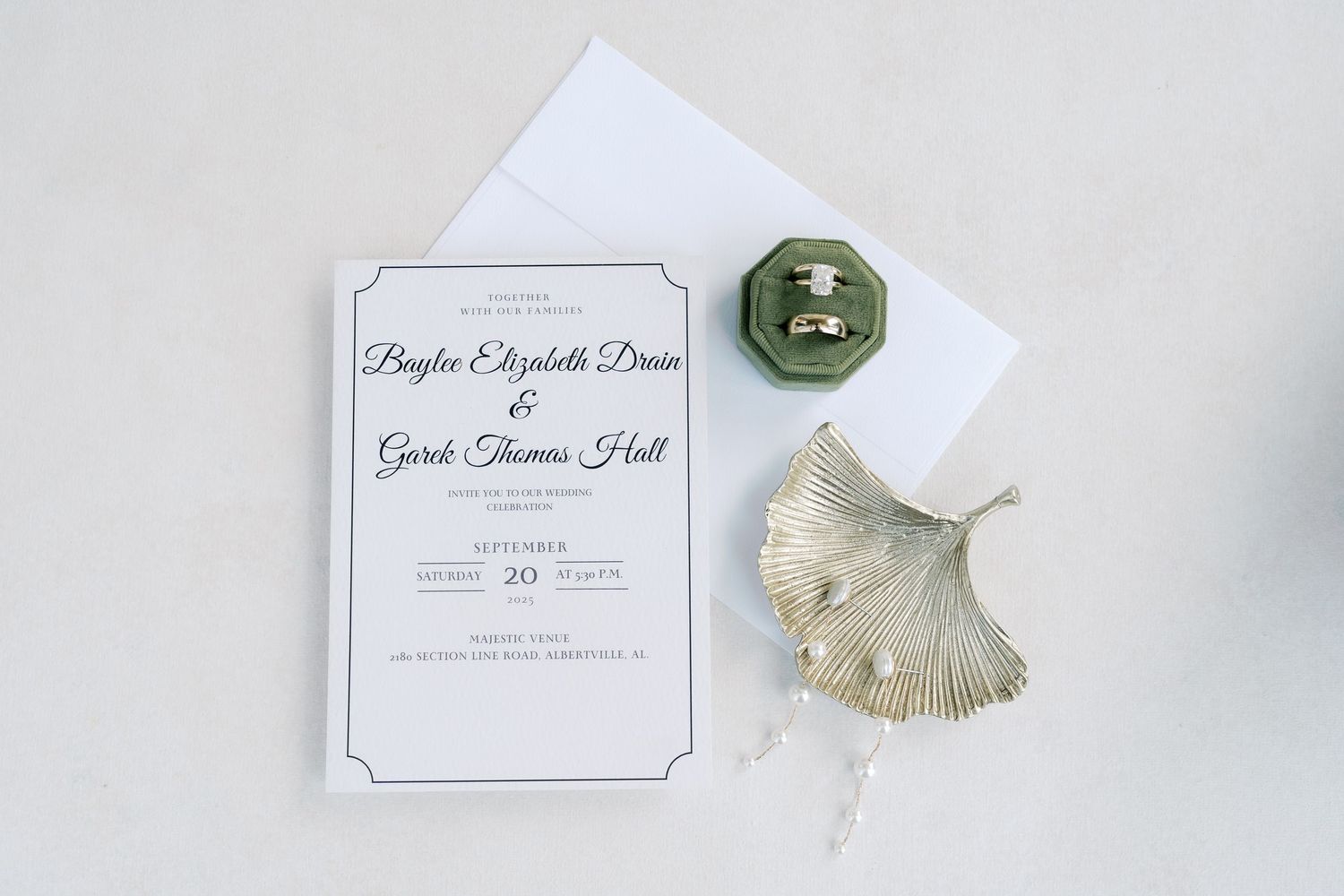 Elegant wedding invitation and decorative elements styled on white background with soft lighting.