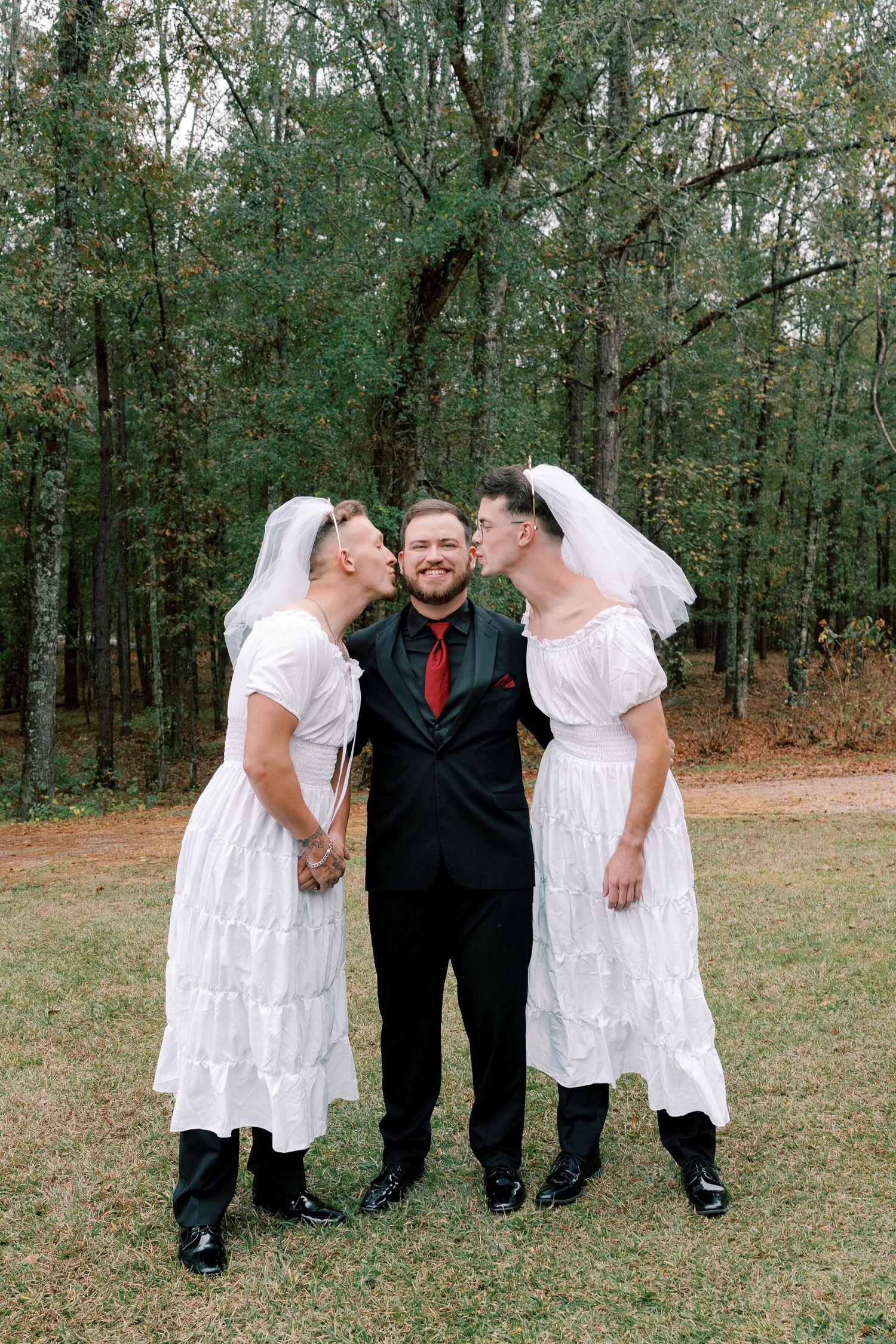 Wedding group shares candid moments in casual poses outdoors.