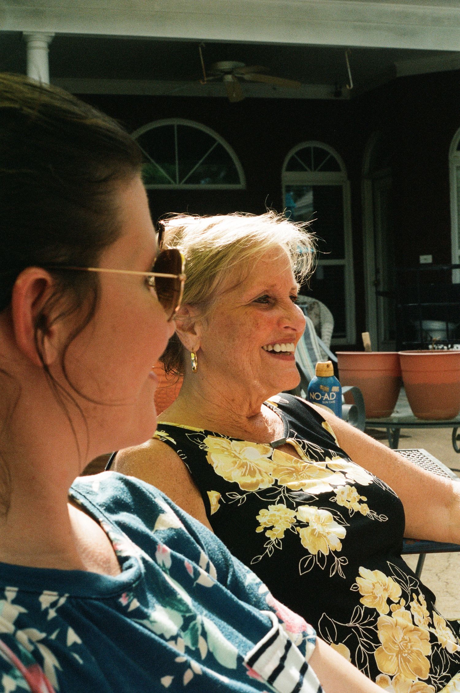 People sitting in a car enjoying a sunny day with bright smiles.