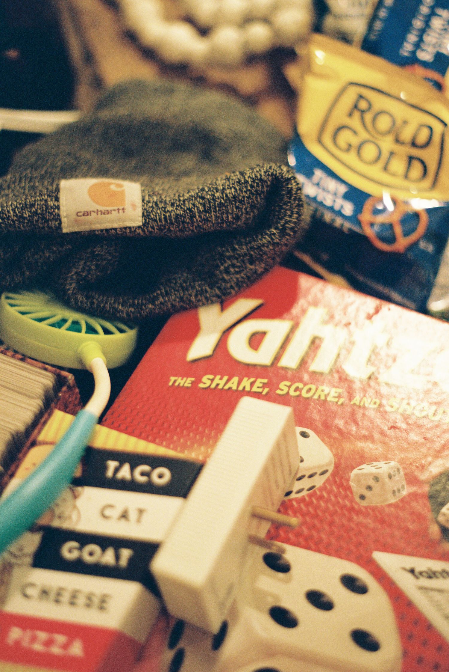 Close-up of various board game cards including taco, pizza, and cat themed designs.