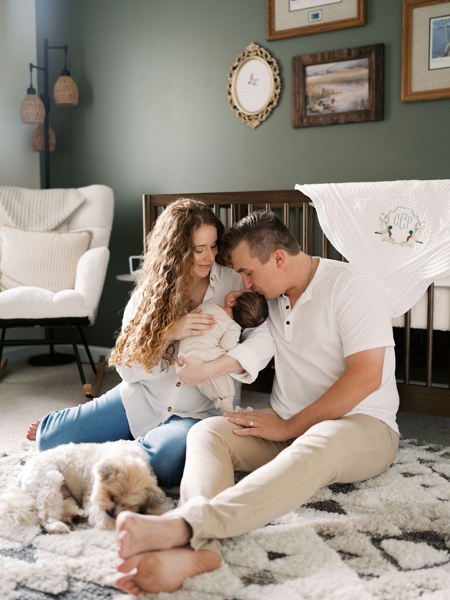 Tender family moment shared while lounging on plush carpet in stylish nursery room.