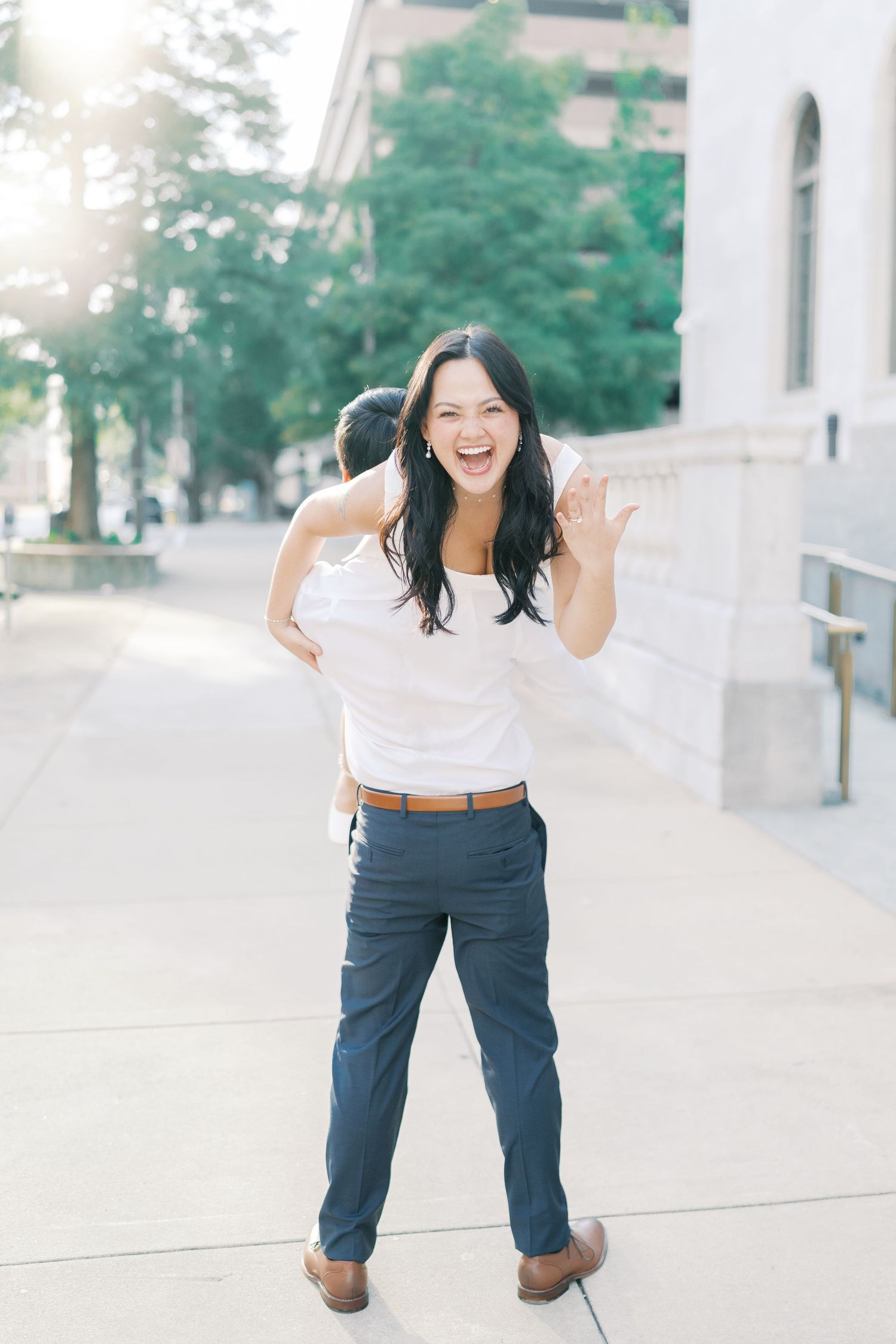 Candid shots of a person in white top and navy pants showing playful expressions outdoors.