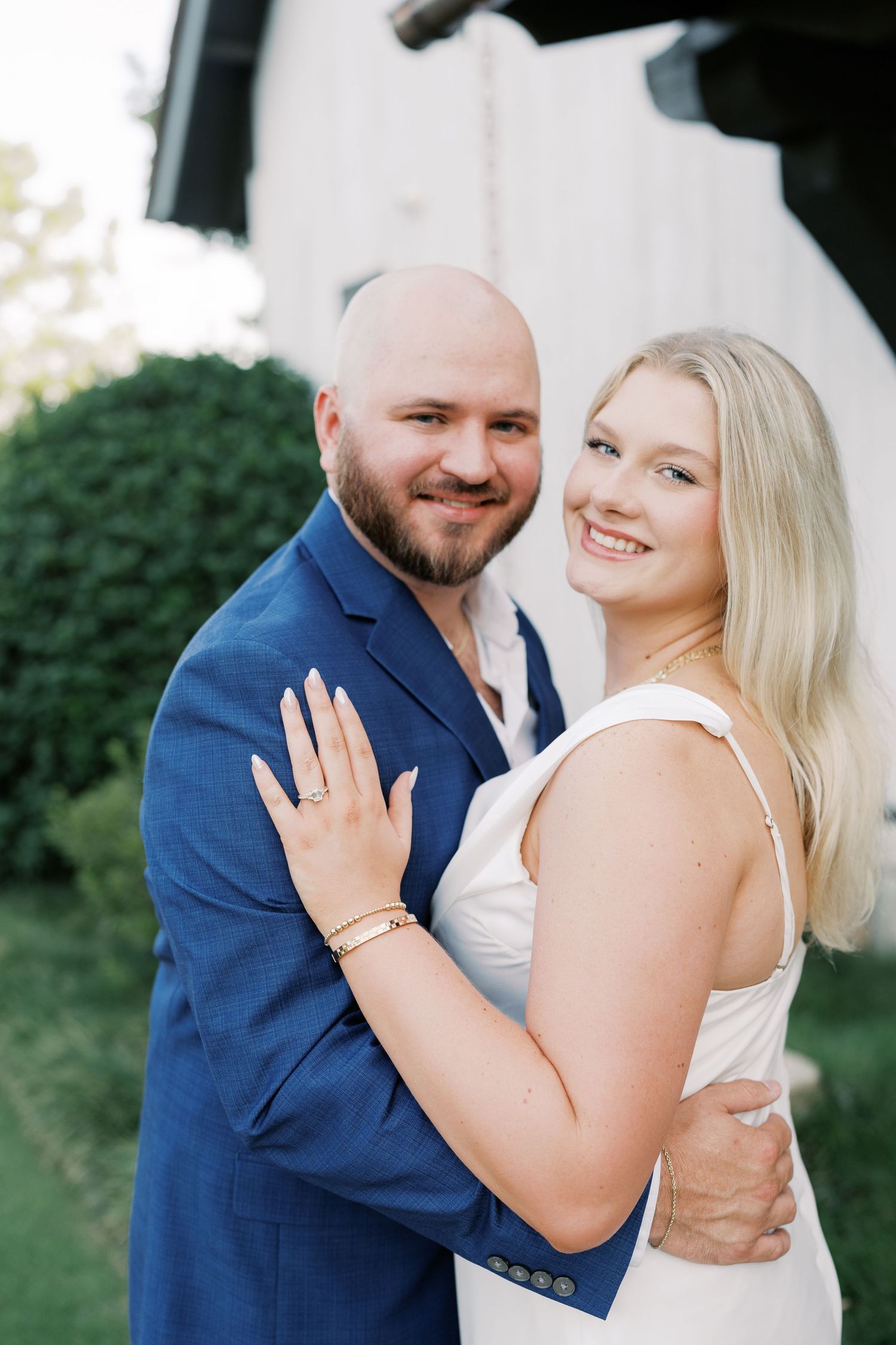 Couple embracing and laughing together during outdoor photo session.