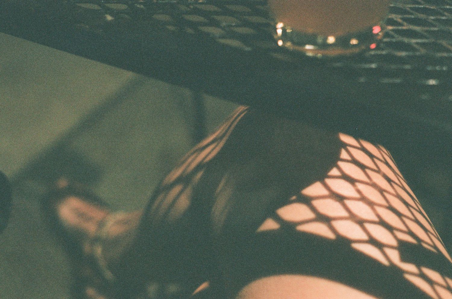 Geometric pattern of dark metal mesh creating an abstract industrial texture.